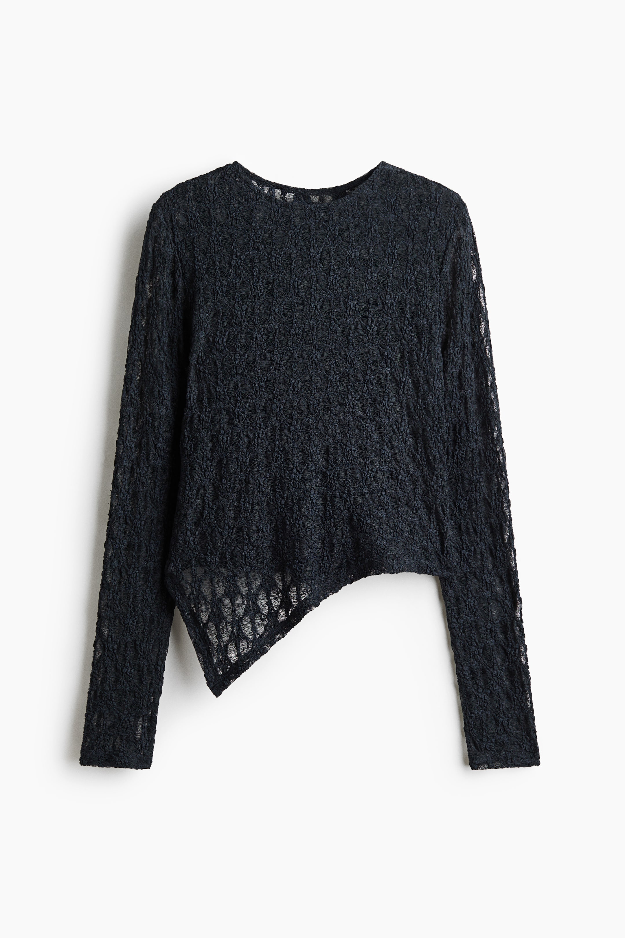 View larger image: A black long-sleeved top made of semi-sheer textured lace is shown from the front, featuring a round neckline. The garment is designed with a distinctive asymmetrical hemline sloping diagonally to create a pointed drape on one side.