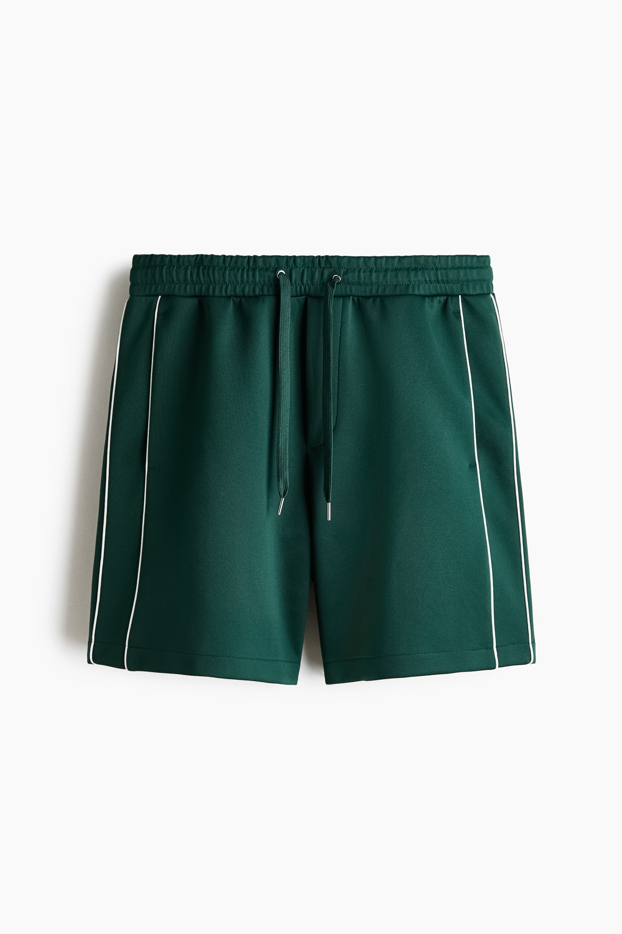 View larger image: The dark green shorts feature an elastic waistband with metal-tipped drawstrings, complemented by a white stripe running vertically along each outer side seam.