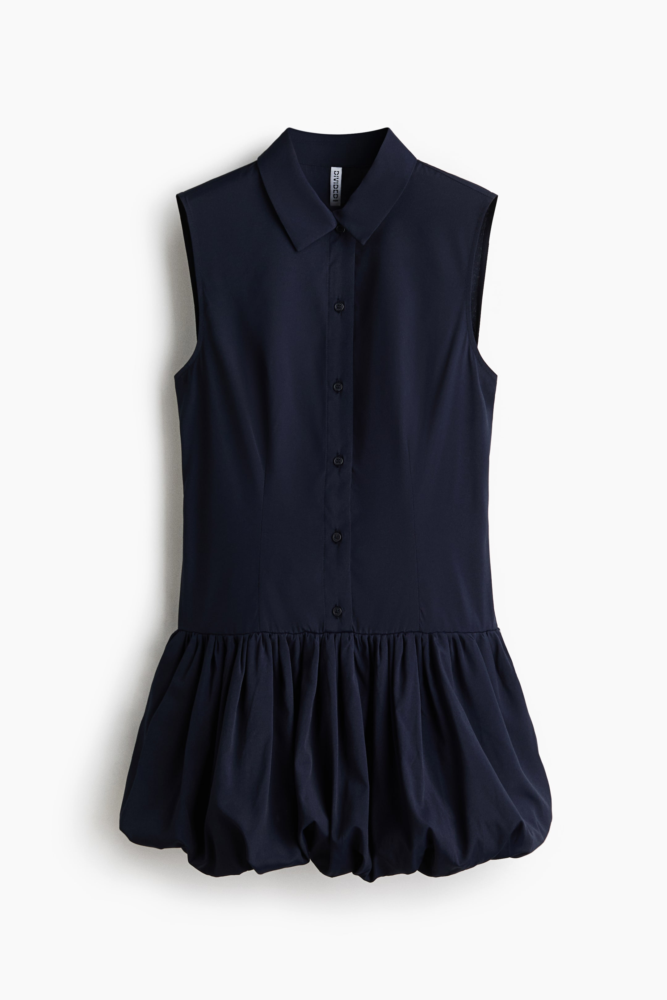 View larger image: The navy blue sleeveless dress is seen from the front, featuring a classic collar and a button-front placket running down the bodice. The fitted bodice transitions into a voluminous bubble skirt that is gathered at the hem.
