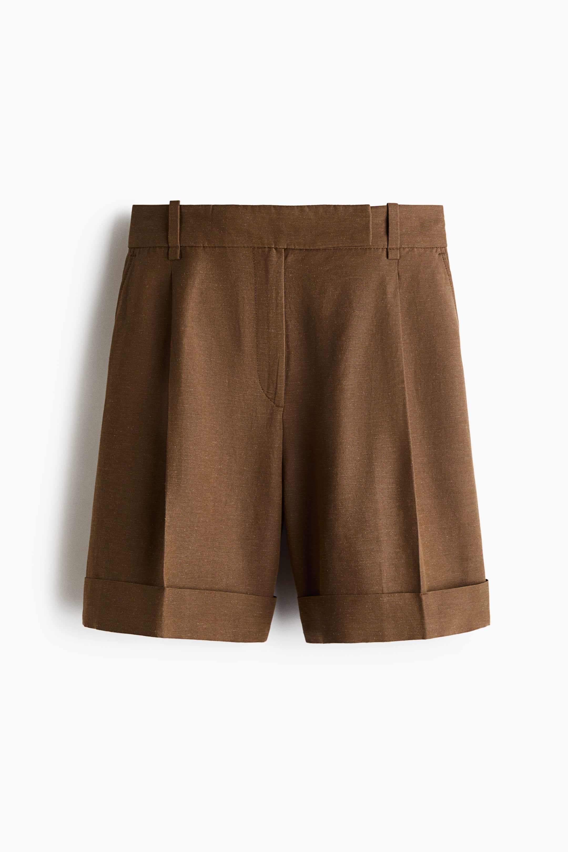 View larger image: Brown shorts are shown from the FRONT, showcasing a flat waistband complete with belt loops, a fly zipper closure, and front pleats. The shorts are finished with cuffed hems.