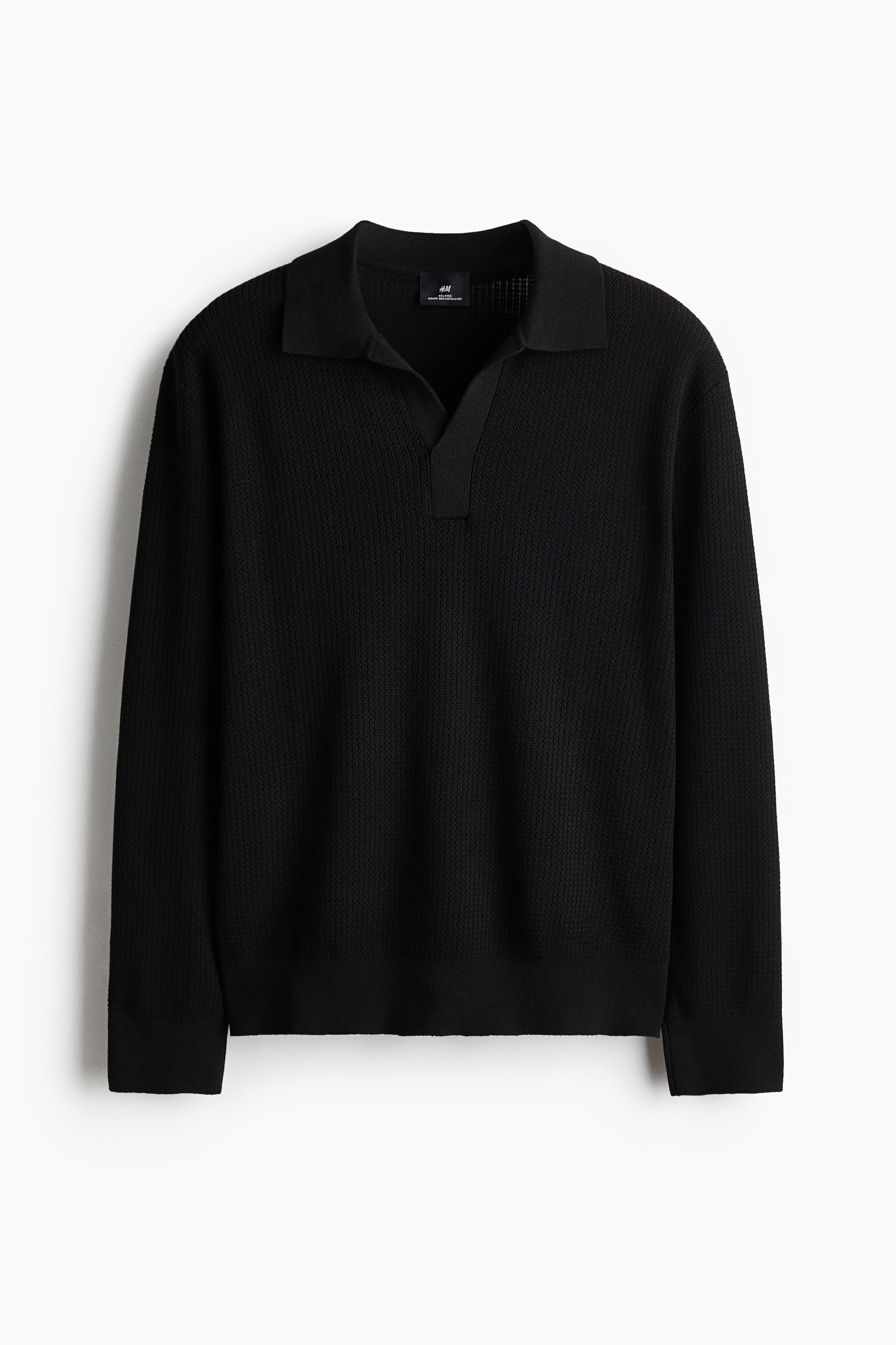 View larger image: A black long-sleeved knit polo shirt is facing front, featuring a classic collar and an open V-neck placket. It displays a textured knit pattern throughout the body and sleeves, finished with ribbed cuffs and a ribbed hem.