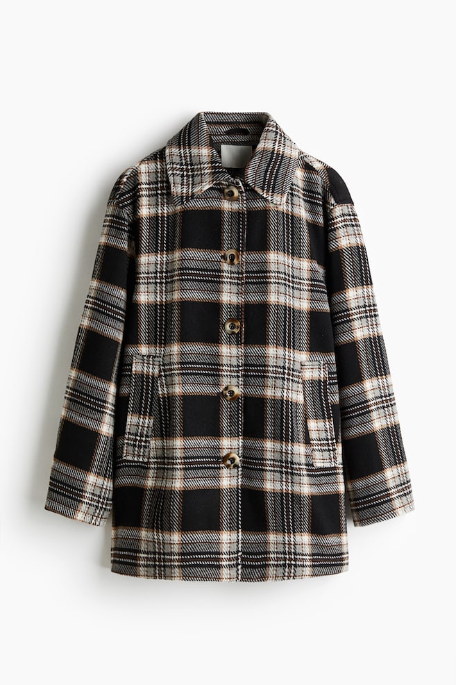A black, white, grey, and tan plaid jacket is presented from the front, featuring a pointed collar, a front button closure with four brown buttons, and two patch pockets on the lower front. - 1