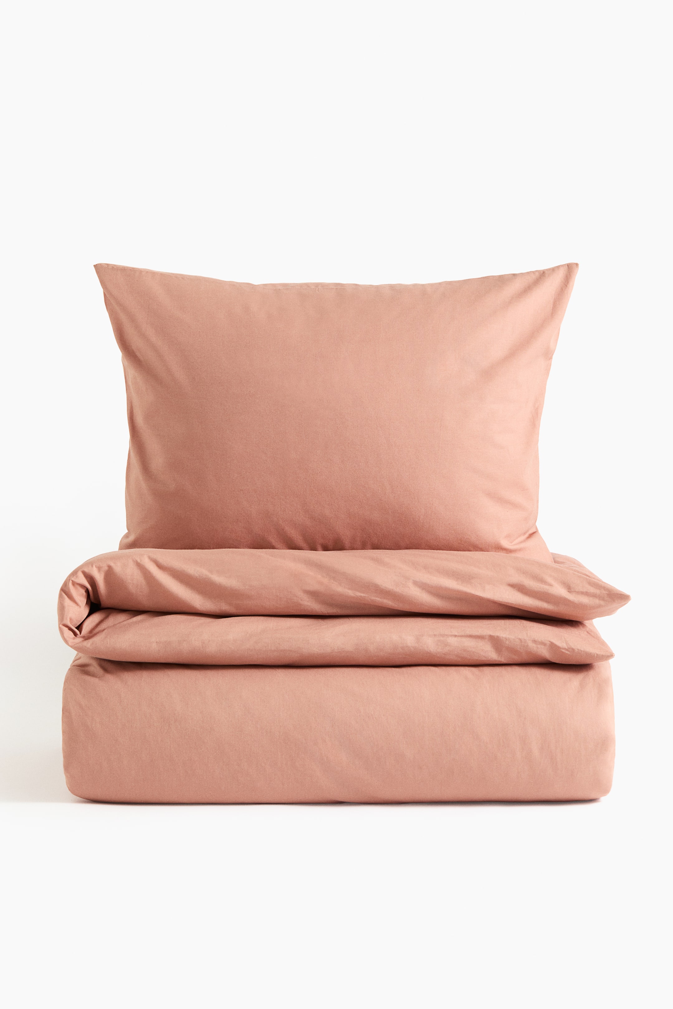 View larger image: A dusty rose bedding set comprised of a plump pillowcase resting atop a neatly folded duvet cover, both presented front-facing.
