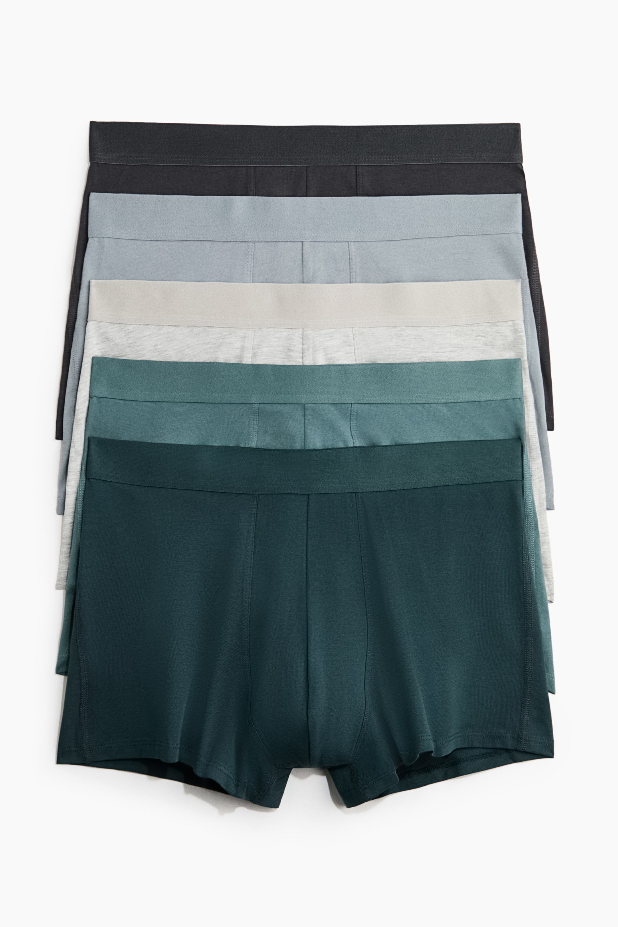 View larger image: Five pairs of men's boxer briefs are stacked, displaying a gradient of colors — dark gray, light blue-gray, light heather gray, medium teal, and dark teal. Each pair features an elastic waistband and visible front seams.