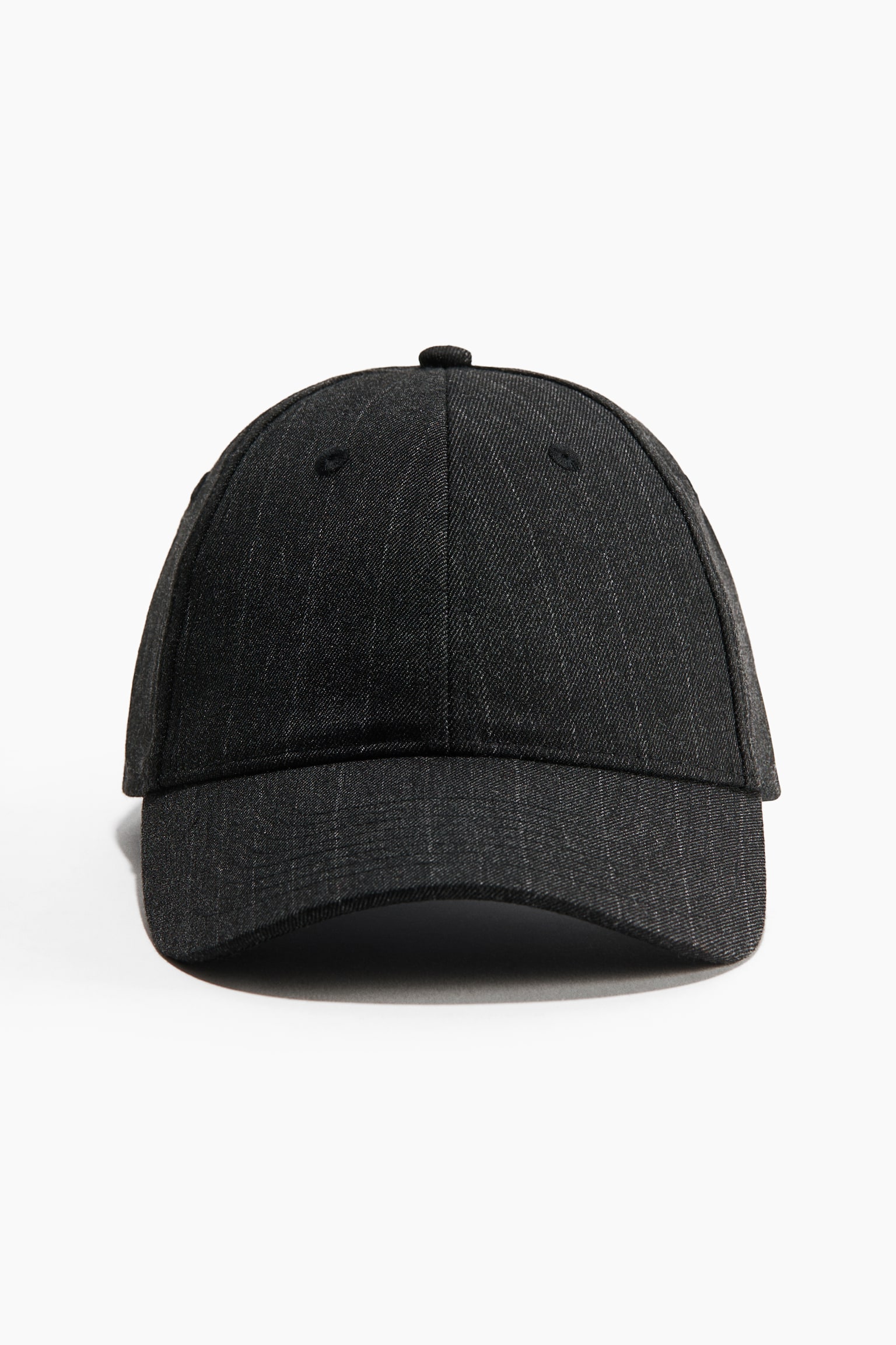 A dark grey pinstripe baseball cap is facing forward, showcasing its structured six-panel design and curved brim. The cap features a textured fabric with subtle vertical stripes, embroidered eyelets on the front panels, and a matching top button.