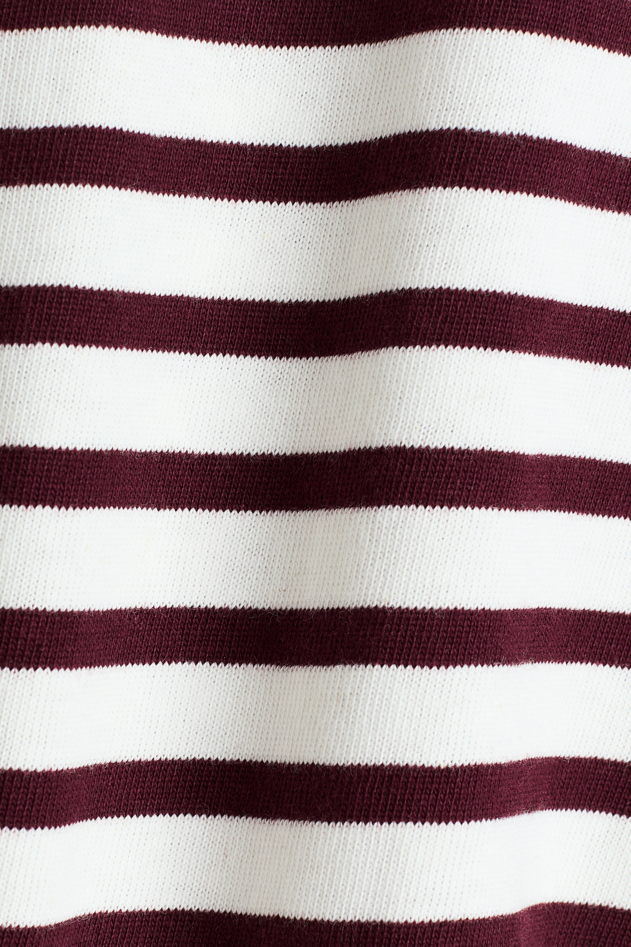 View larger image: The fabric features horizontal stripes in white and dark red, showcasing a knitted texture with subtle folds.