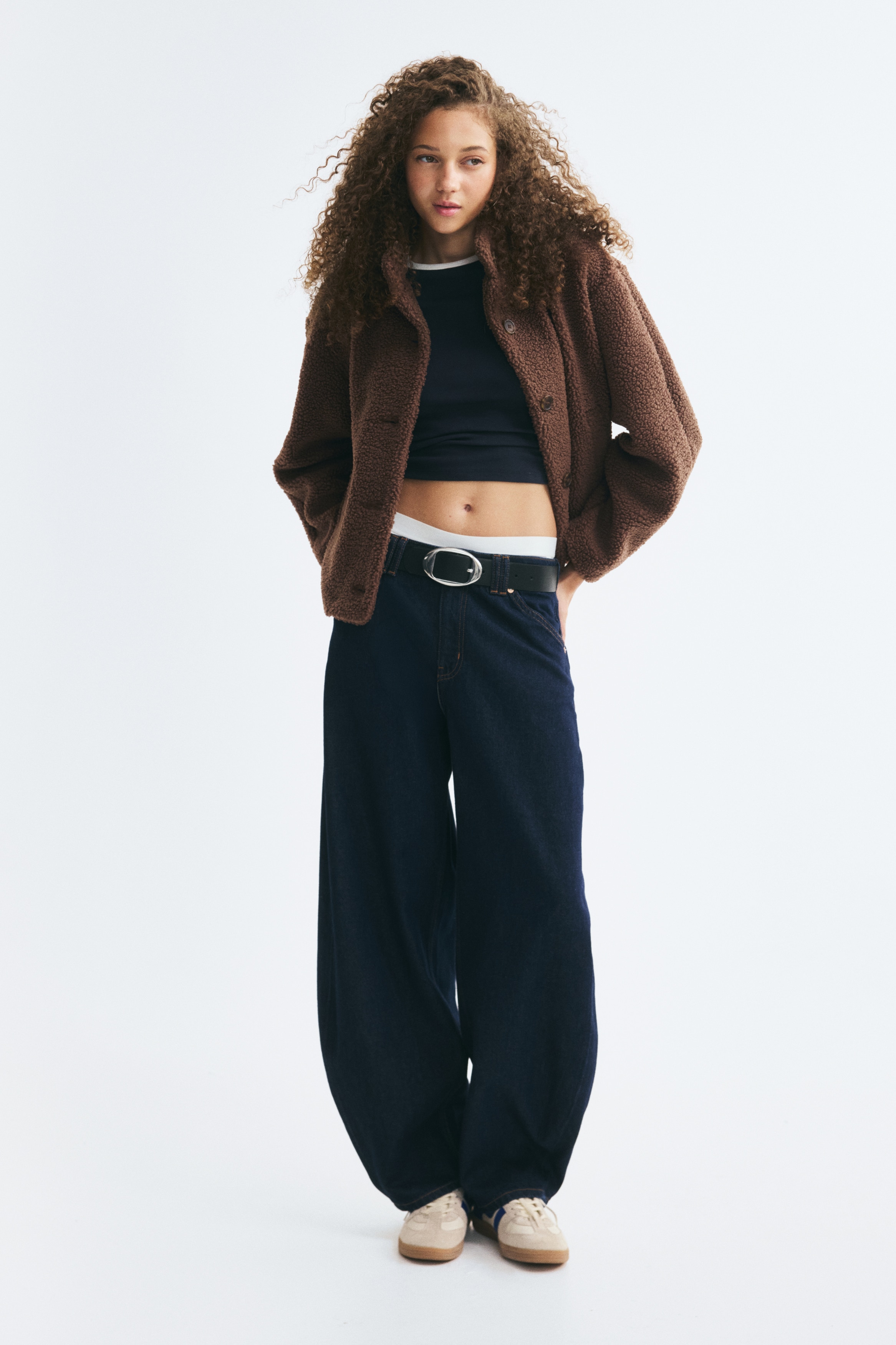 Má»t chiáº¿c Ã¡o khoÃ¡c teddy fleece mÃ u nÃ¢u ÄÆ°á»£c chá»¥p chÃ­nh diá»n, ná»i báº­t vá»i cháº¥t váº£i pile cÃ³ bá» máº·t sáº§n, cá» Äá»©ng vÃ  hÃ ng nÃºt cÃ i phÃ­a trÆ°á»c. Ão cÃ³ tay dÃ i dÃ¡ng suÃ´ng thoáº£i mÃ¡i vÃ  hai tÃºi viá»n bÃªn hÃ´ng.