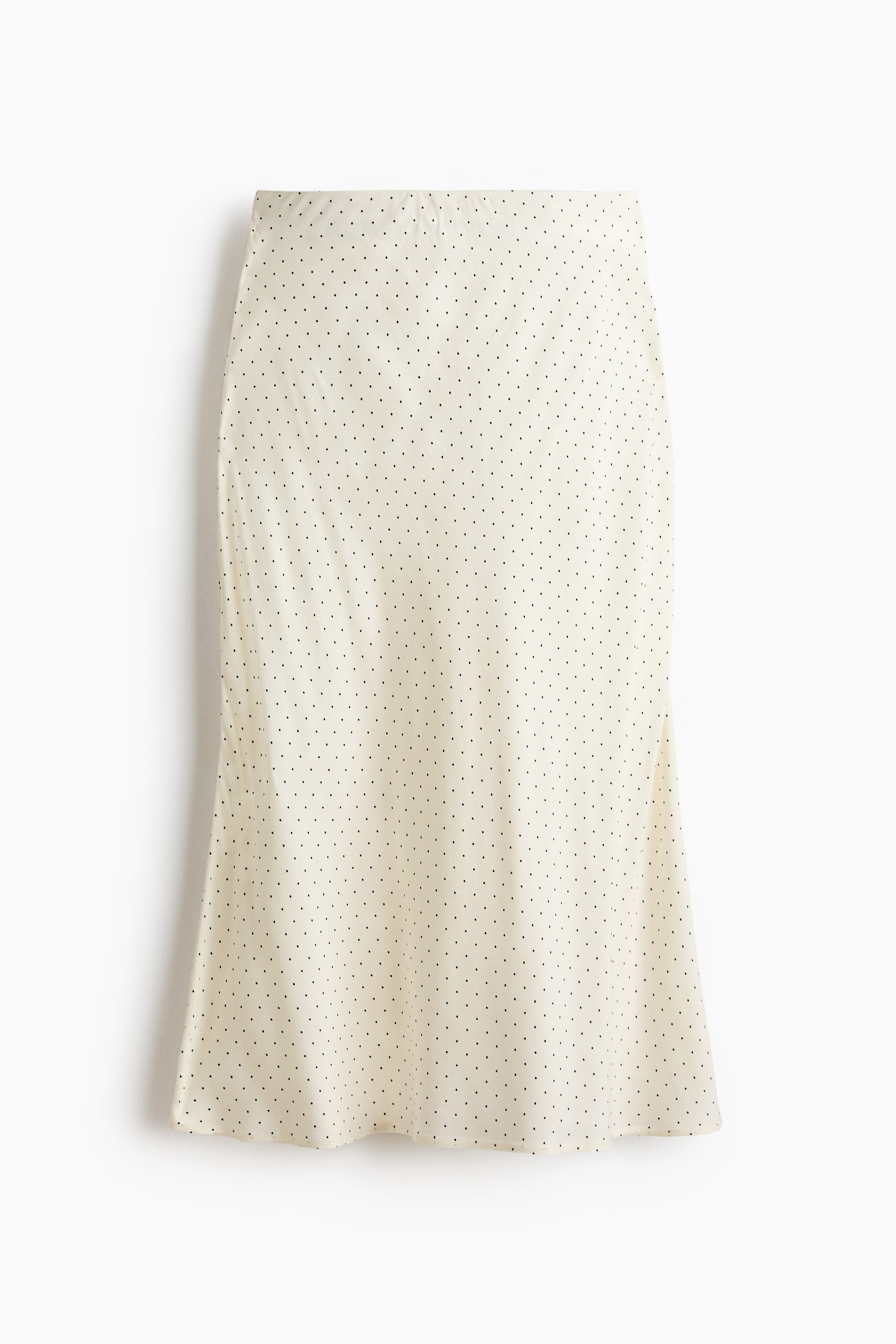 View larger image: The skirt, reaching calf-length, is displayed from the front, showcasing a high waist and a softly draping weave with a subtle sheen. It features a pattern of small black polka dots on an off-white background, gently flaring towards the hem.