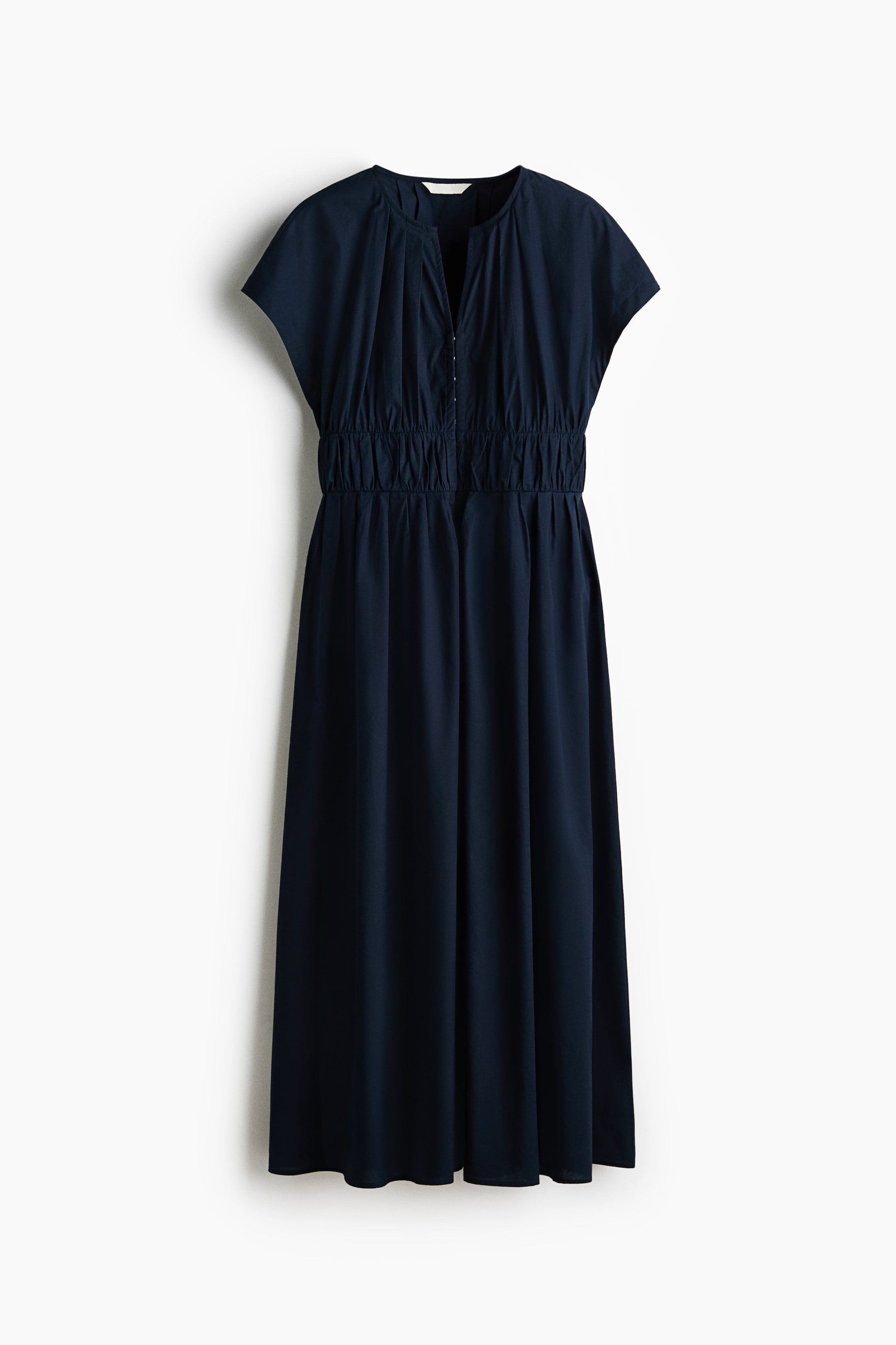 View larger image: A dark-blue midi dress, shown from the front, features a split-neck with a small hook-and-eye closure, short cap sleeves, and a gathered bodice above an elasticated, ruched waistline, flowing into an A-line skirt.