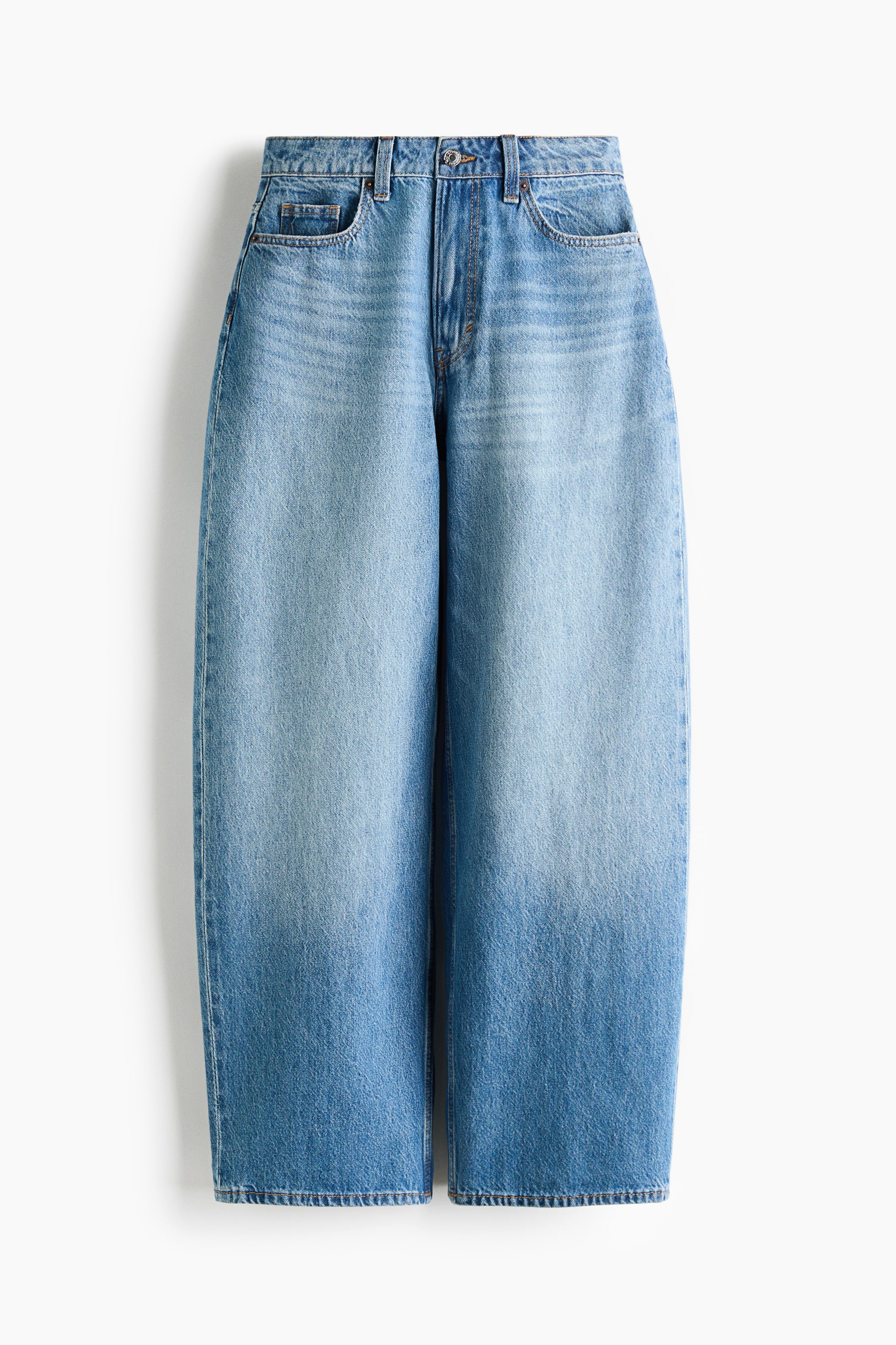 View larger image: These wide-leg jeans showcase a light blue denim wash that gradually fades to a darker blue towards the hem. They feature a high-rise waist with a button and zipper fly, two front scoop pockets, and a coin pocket.