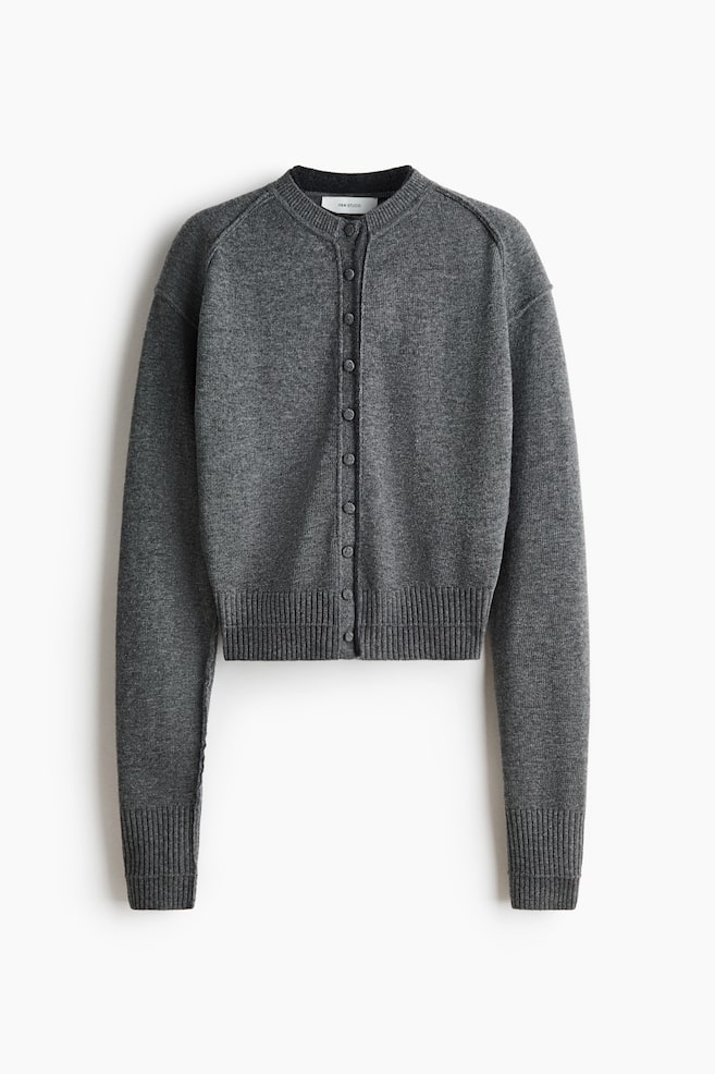 A dark grey cardigan is facing forward, featuring a band collar and a full button-front closure. It is displaying long raglan sleeves with ribbed cuffs and a ribbed hem. - 1