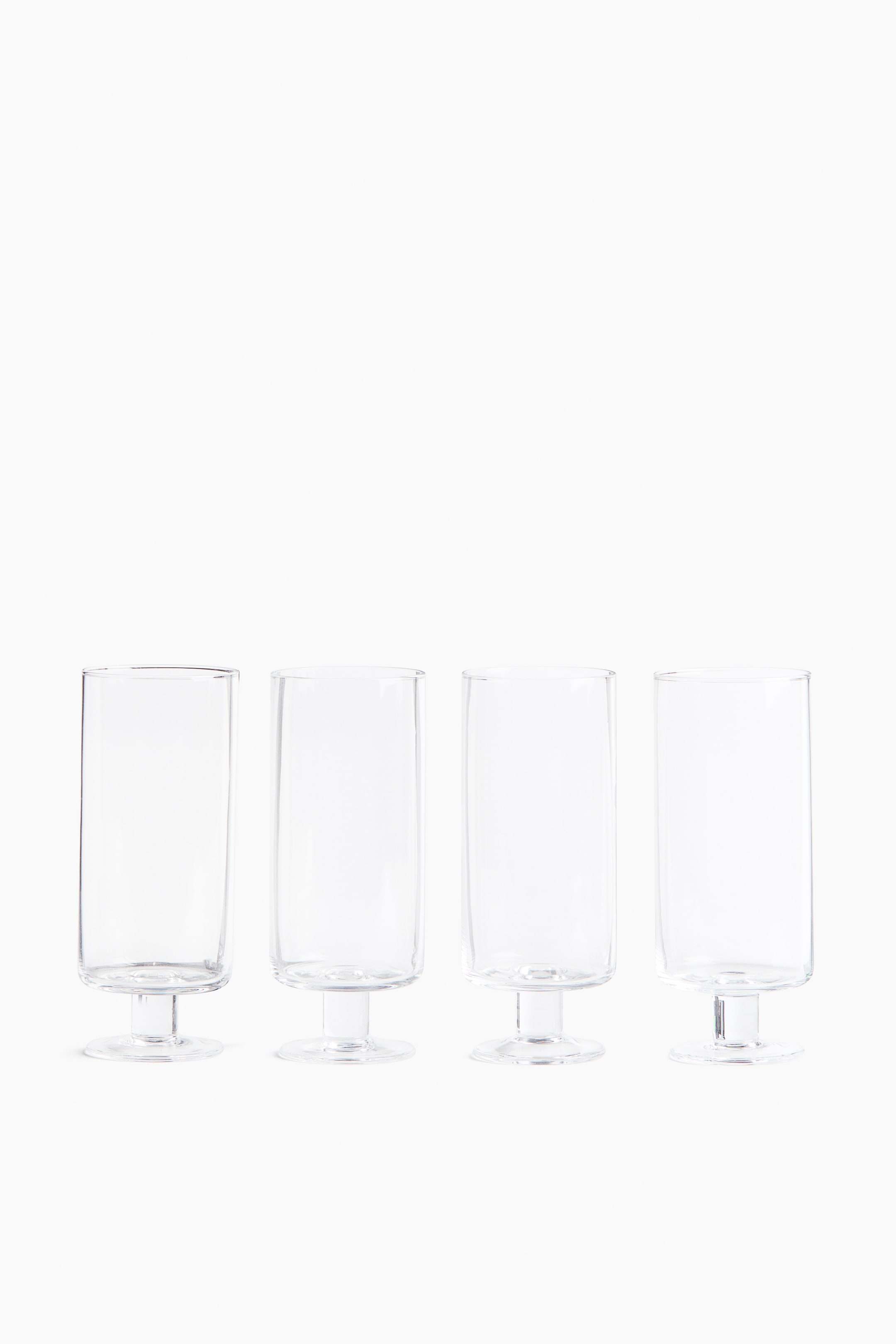 View larger image: Four mouth-blown, footed highball glasses are standing in front, each featuring a straight-sided design and a 300 mL capacity.