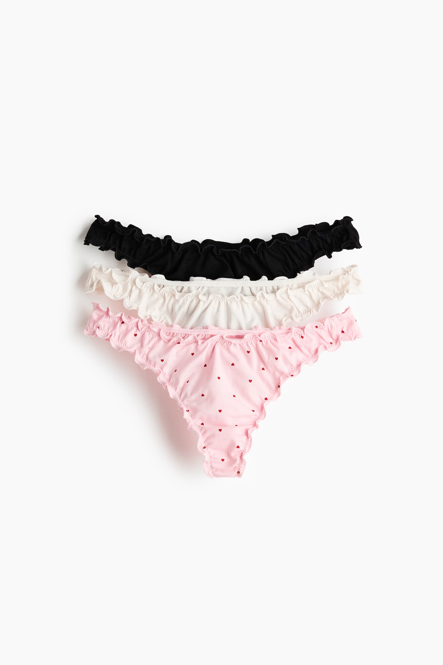 Figi thong z owerlokowym wykończeniem 3-pak - Jasnoróżowy/Serca/Ciemnobrązowy/Kropki/Kremowy/Serca/Biały/Kwiaty/Różowy/Kwiaty/Jasnobeżowy/Panterka/Czerwony/Wzór - 1