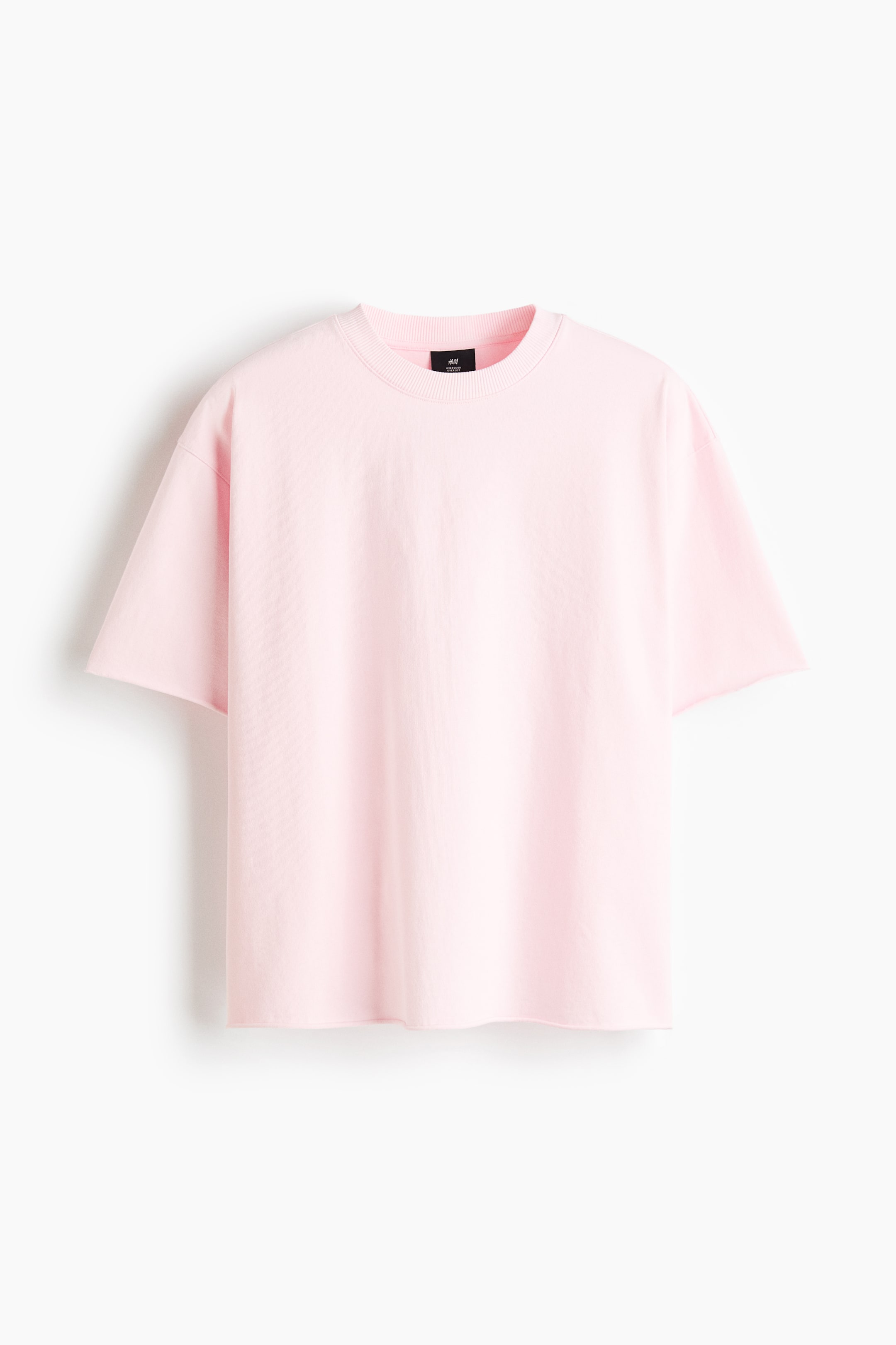 View larger image: A pink t-shirt is shown from the front, featuring a ribbed crew neck, short sleeves with dropped shoulders, and a straight hem, offering a relaxed fit.