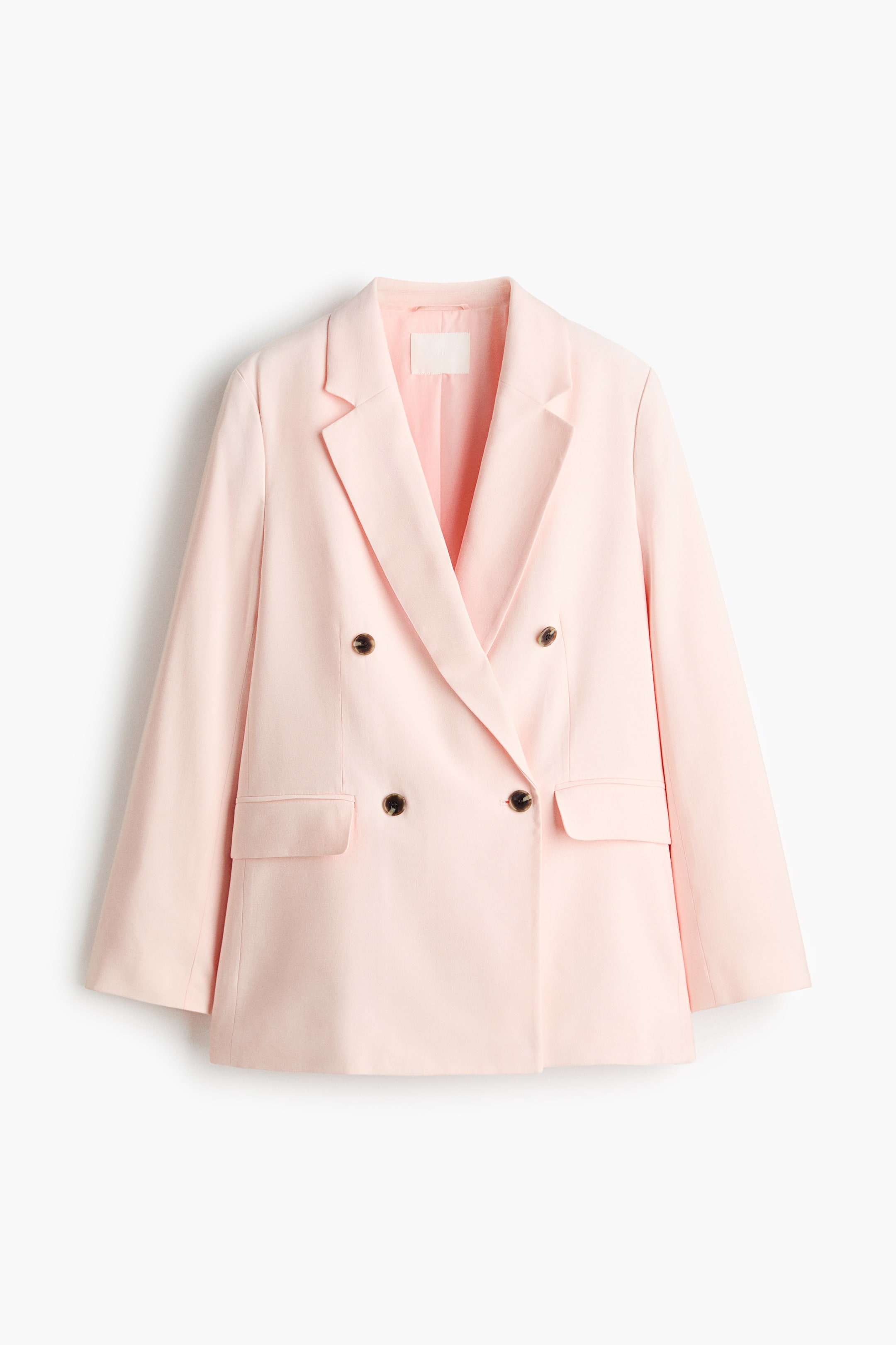 View larger image: A light pink, slightly longer, double-breasted blazer is showcased from the front. It features notch lapels, front buttons, shoulder pads, long sleeves, and jetted front pockets with a flap, and is lined.