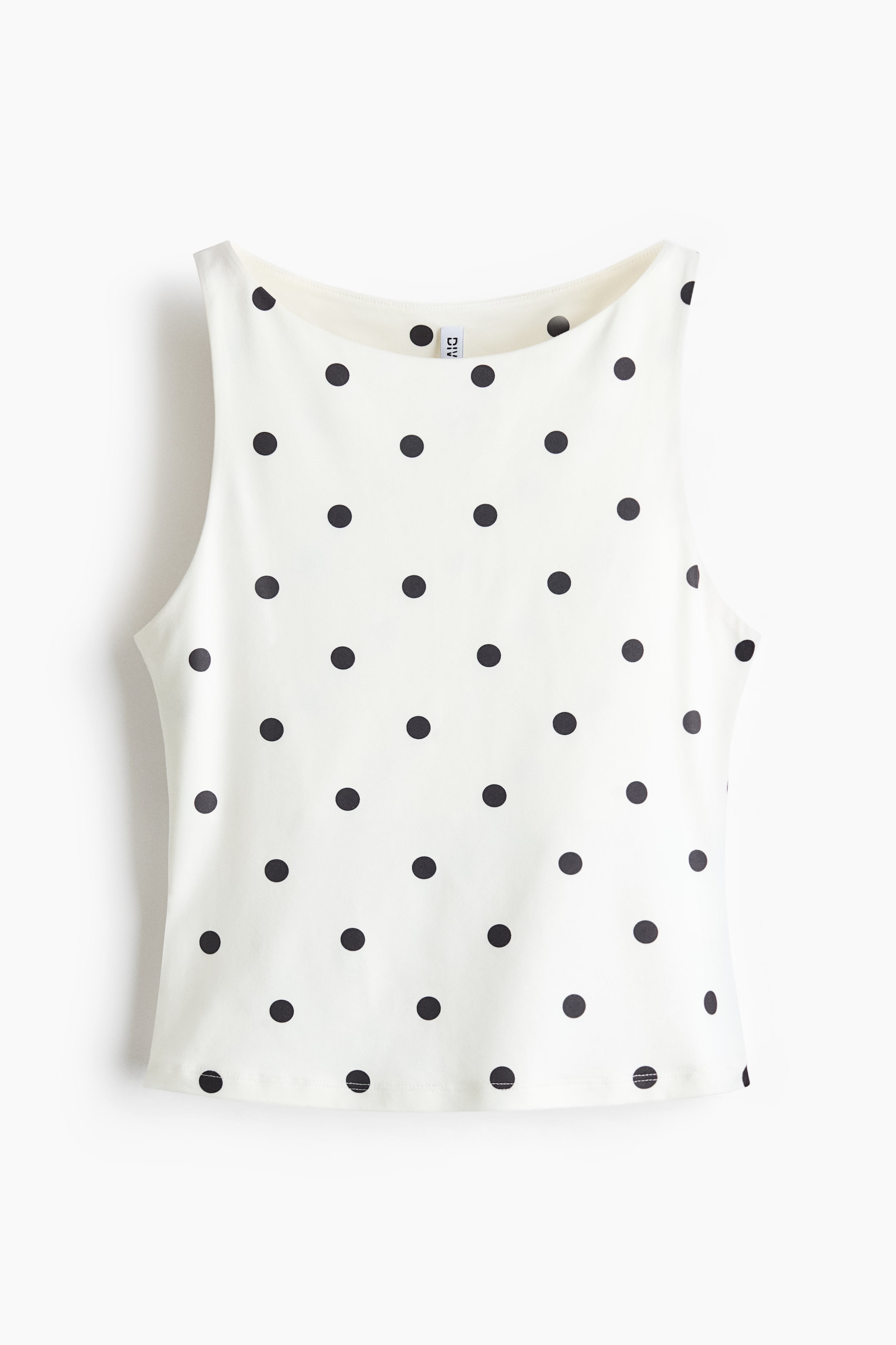 View larger image: "A white sleeveless top featuring a black polka dot pattern, designed with a high, rounded neckline and a straight hem, showcased from the front."