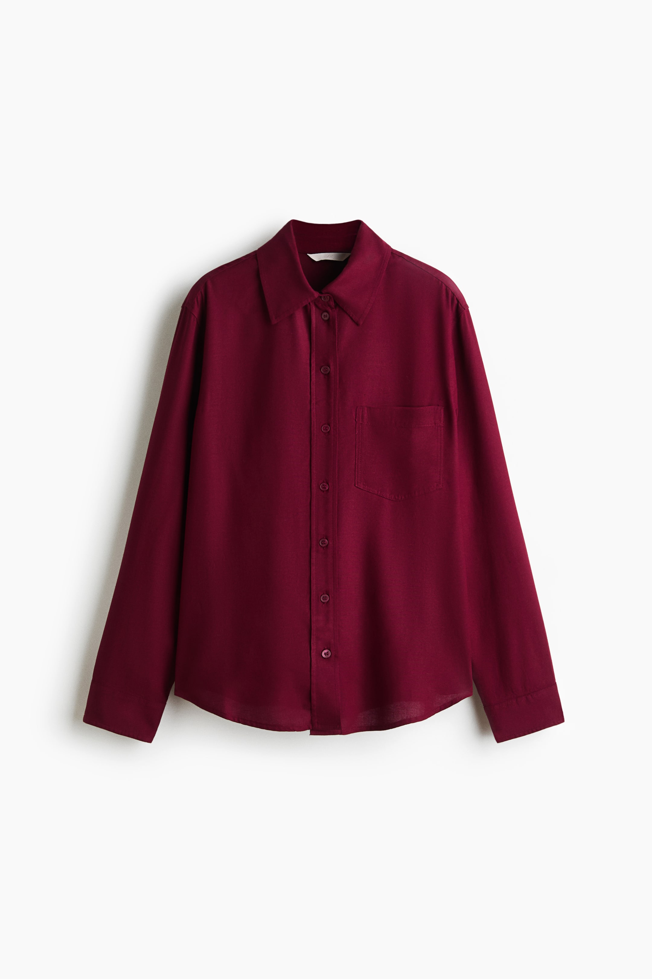 View larger image: A deep red shirt is shown from the front, featuring a collar, buttons down the front, a patch chest pocket, long sleeves with buttoned cuffs, and a rounded hem.