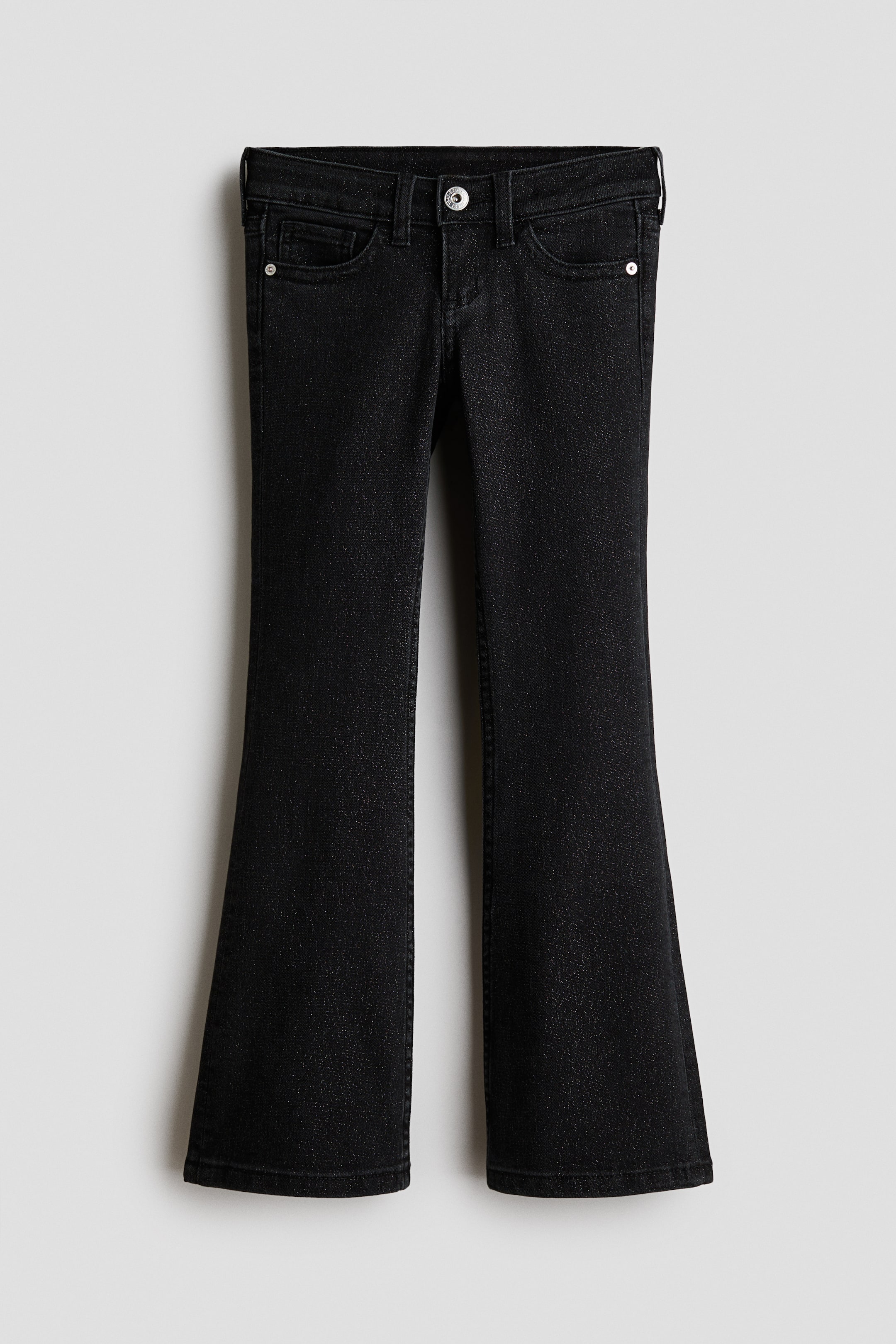 Grotere afbeelding bekijken: Zwarte gewassen katoenen denim jeans worden van voren getoond, met een lage taille met een knoopsluiting en een ritssluiting. De jeans hebben een klassieke five-pocket-stijl met een slim fit rond de heupen en dijen die uitloopt in wijd uitlopende pijpen.