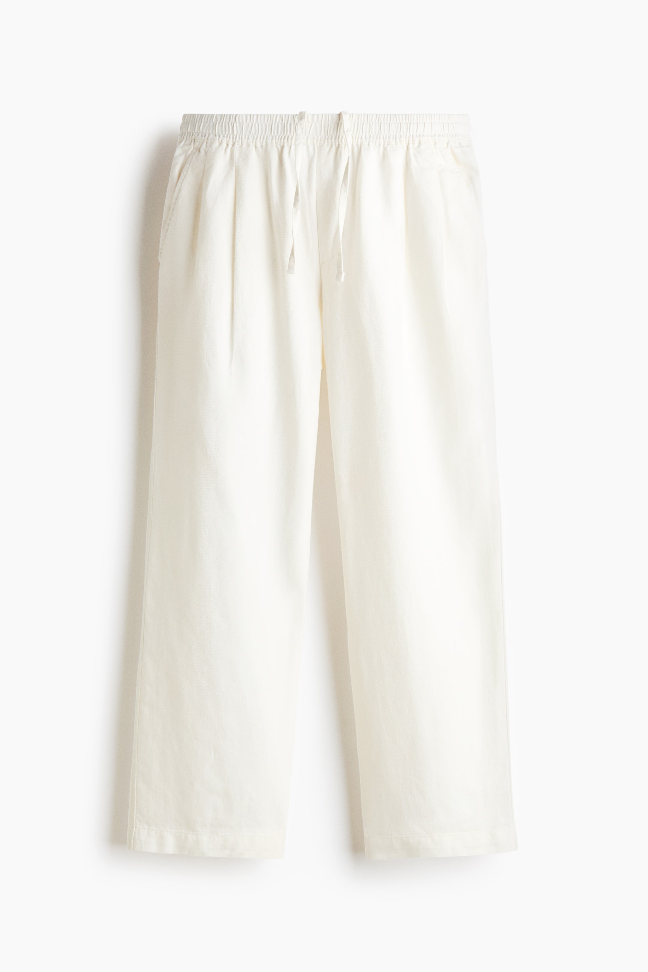 View larger image: A pair of off-white, wide-leg trousers is displayed in a front view, featuring an elasticated waistband with a central drawstring. The trousers have a relaxed fit with subtle front pleating, side slip pockets, and a straight hem.