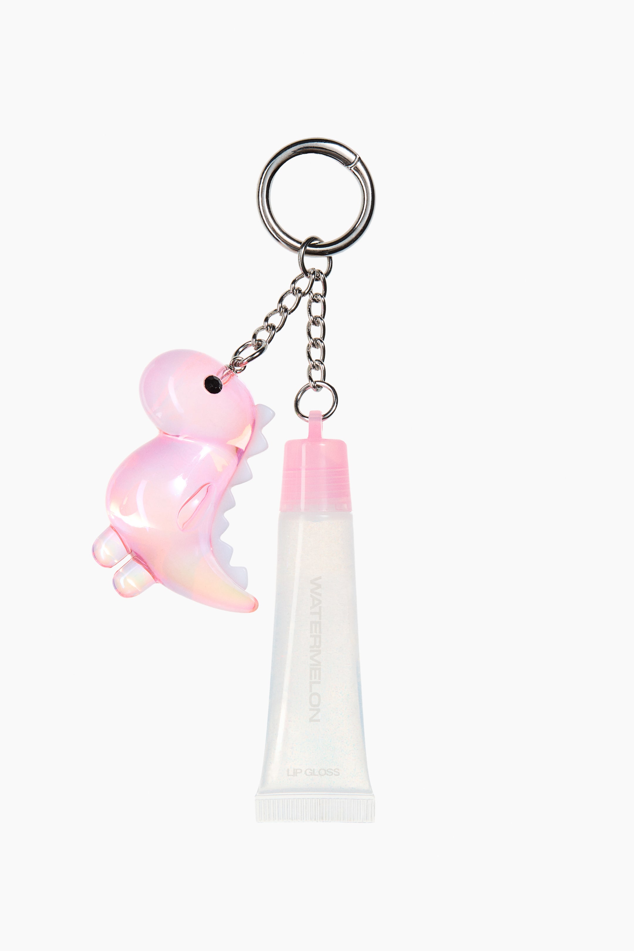 View larger image: A bag charm is shown from the front, featuring a silver-tone metal key ring with two dangling chains. One chain supports an iridescent pink dinosaur-shaped pendant, while the other holds a clear squeeze tube of lip gloss with a pink cap and white text reading "WATERMELON LIP GLOSS."