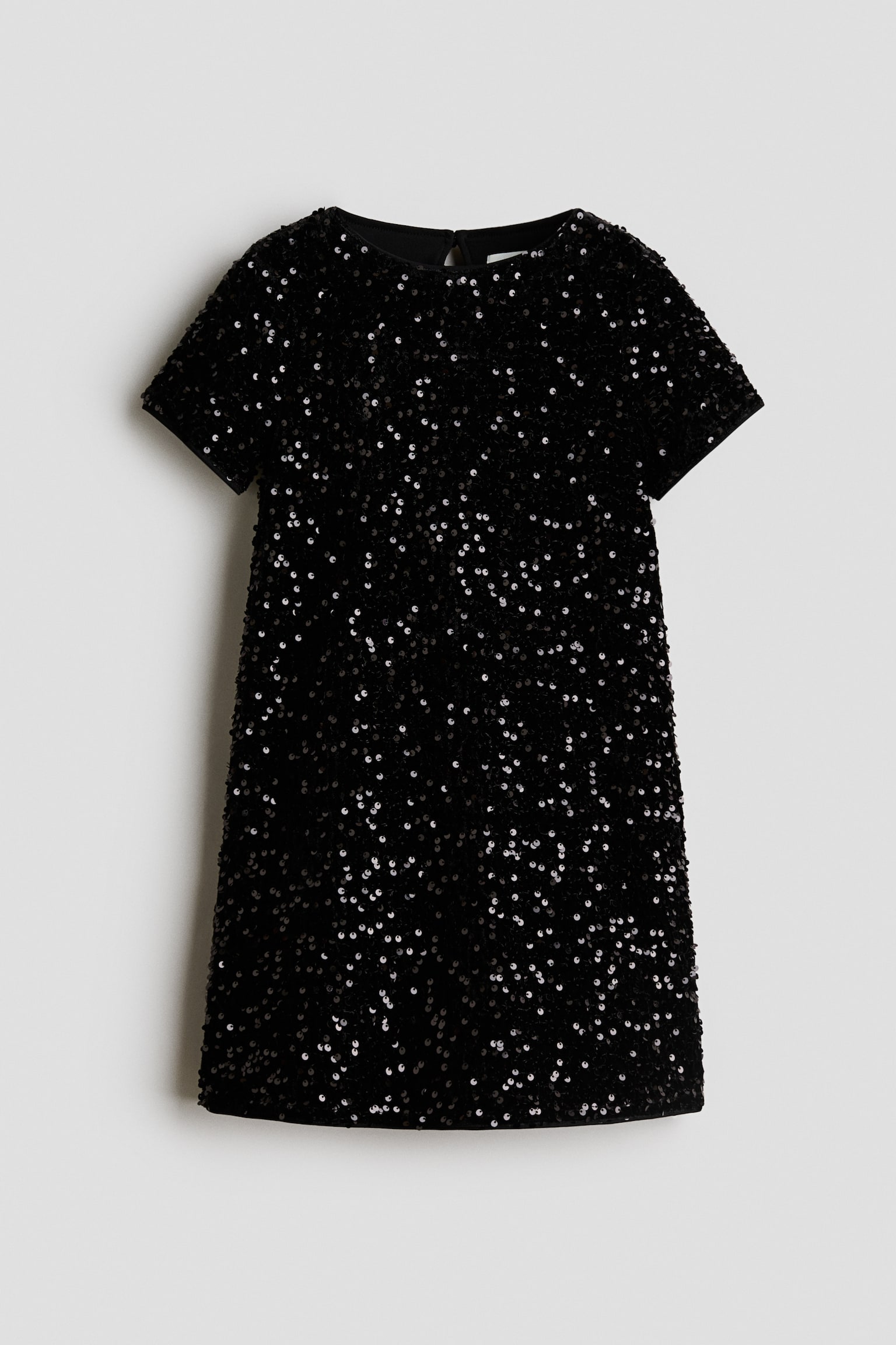 A black sequinned dress is shown front-on, featuring a round neckline, short sleeves, and a straight A-line silhouette. The garment is covered in shimmering black sequins that create a textured, sparkling finish.