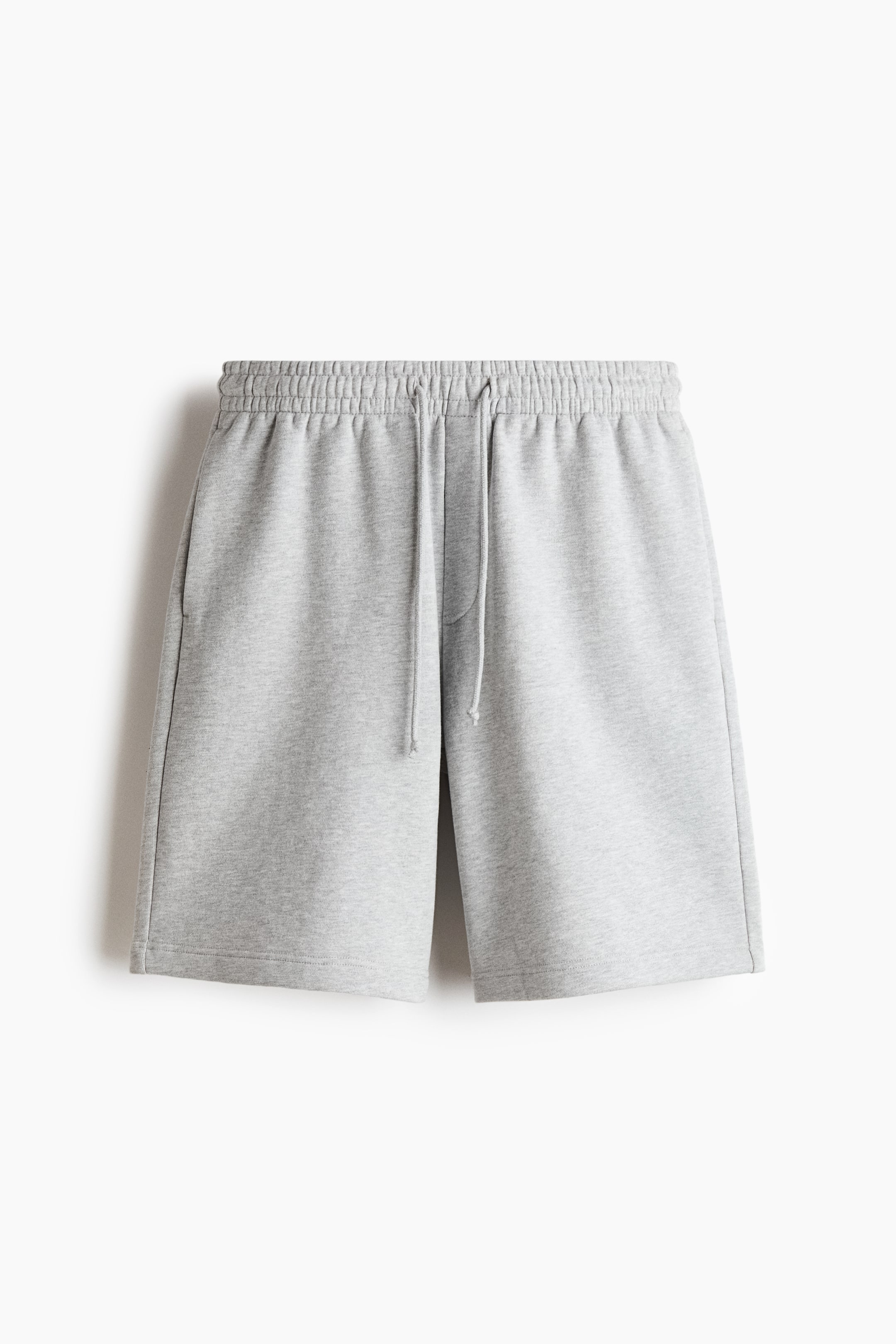 View larger image: Light grey sweatshorts featuring an elasticated drawstring waistband with a visible tie, and two side pockets, presenting a front view.