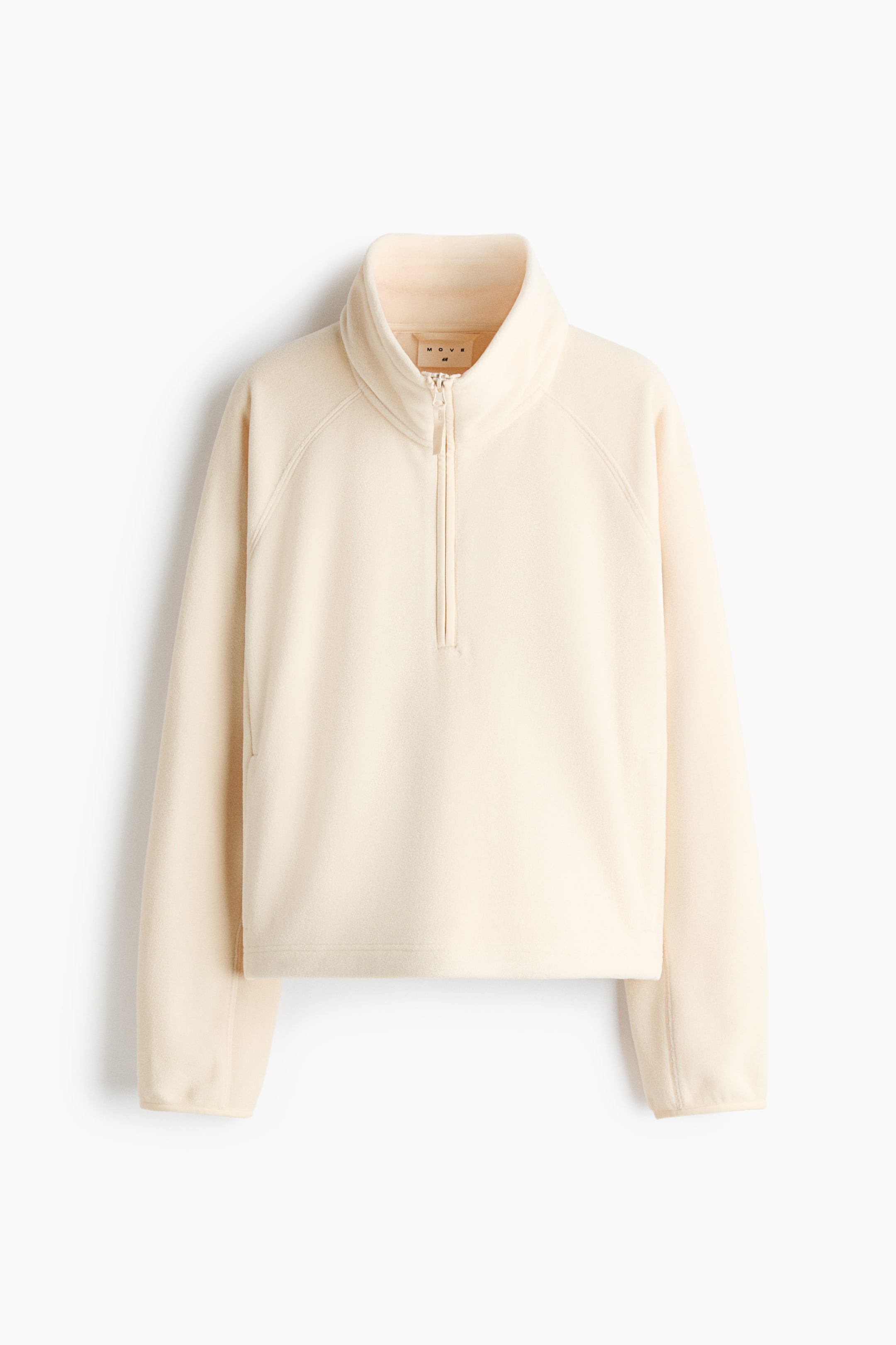 View larger image: A cream-coloured fleece pullover is facing the front, featuring a high stand-up collar with a half-zip closure and long raglan sleeves. The garment is showing a relaxed fit with a straight hem and clean-finished cuffs.