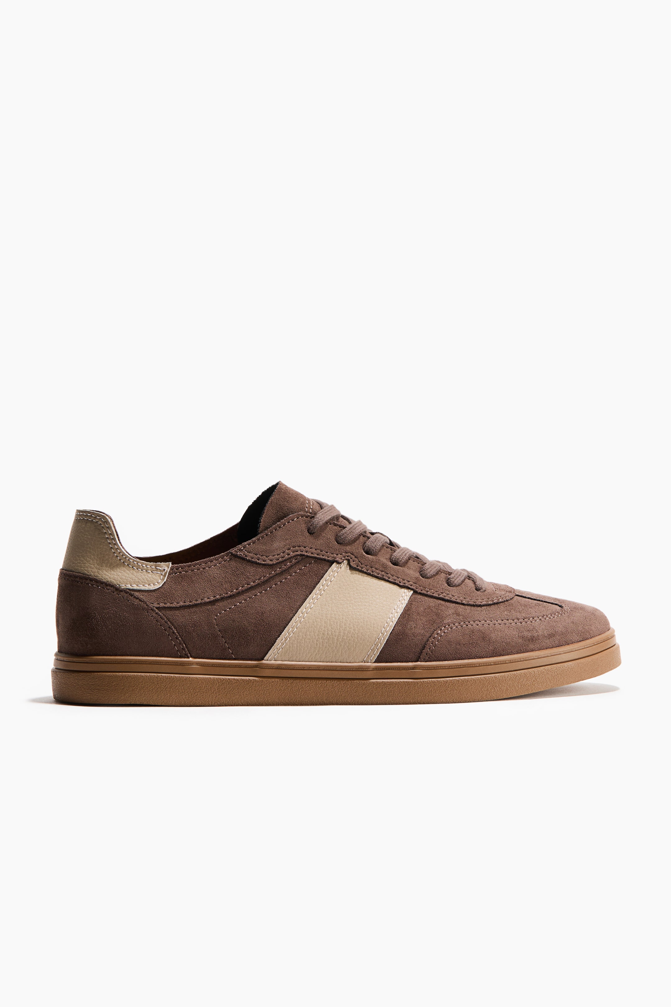 View larger image: A retro-inspired trainer featuring an upper crafted from brown soft napped fabric, accented with lighter beige coated fabric details as a side stripe and heel tab. It showcases a tongue and lacing at the front, a padded top edge, and a brown rubber sole.