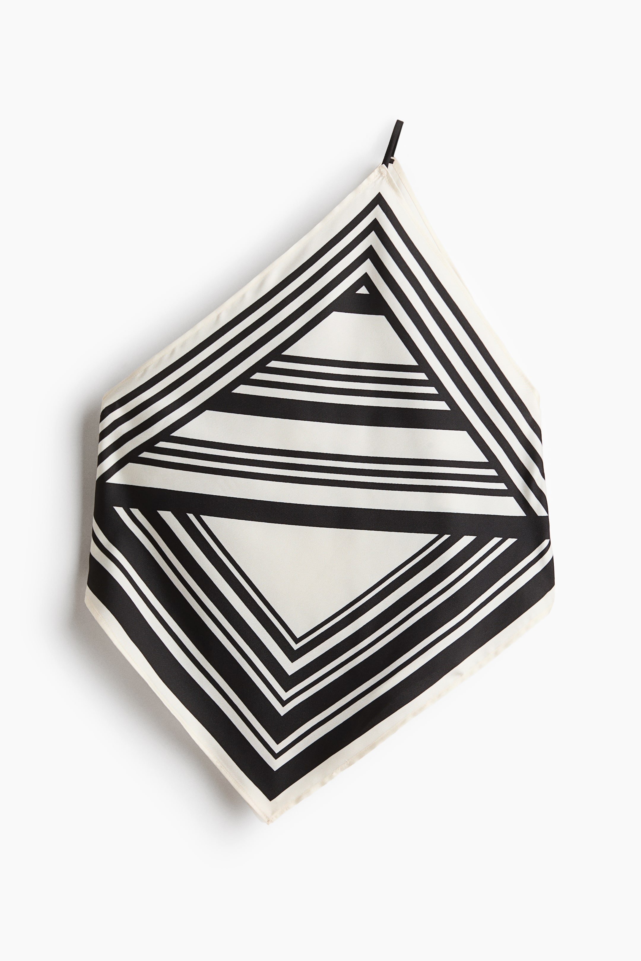 View larger image: A square scarf is shown with its front folded into a diamond shape. It showcases a black and cream geometric pattern with varying stripe widths, creating a large striped diamond outline around a central area filled with horizontal stripes.