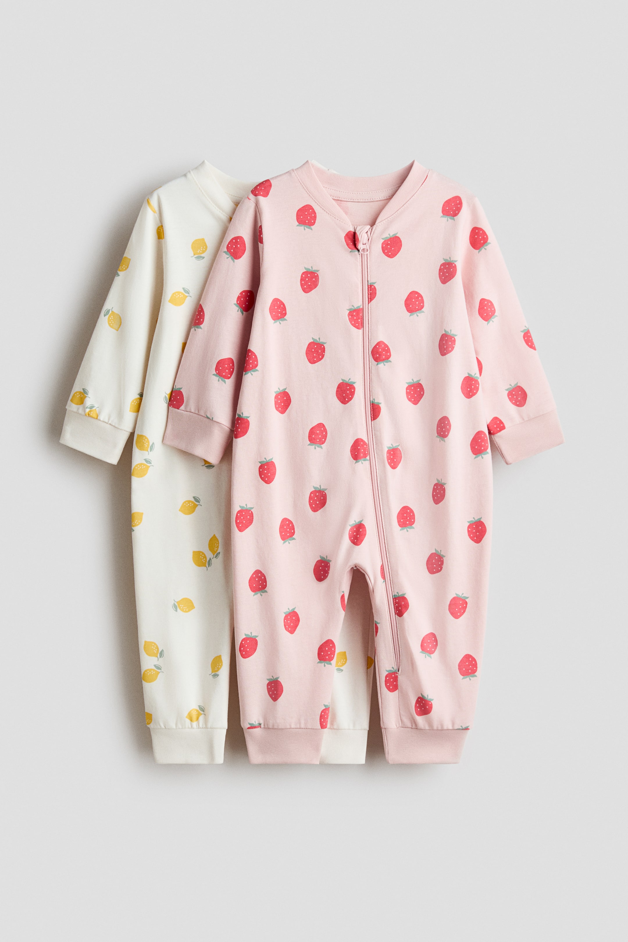 View larger image: Two sleepsuits are presenting front facing, made from soft cotton jersey. 