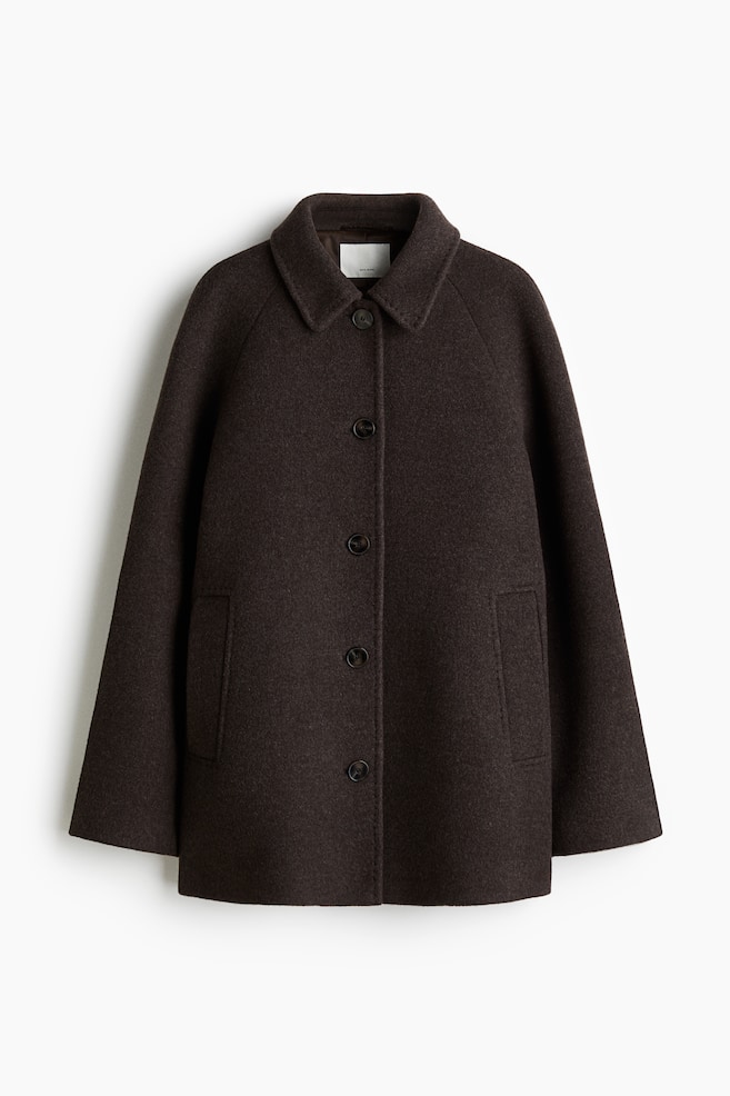 A dark brown A-line car coat is presenting its FRONT, made from a felted wool weave. It is featuring a classic collar, five dark buttons fastening down the front, and two welt side pockets. The coat is designed with long raglan sleeves and is appearing lined. - 1