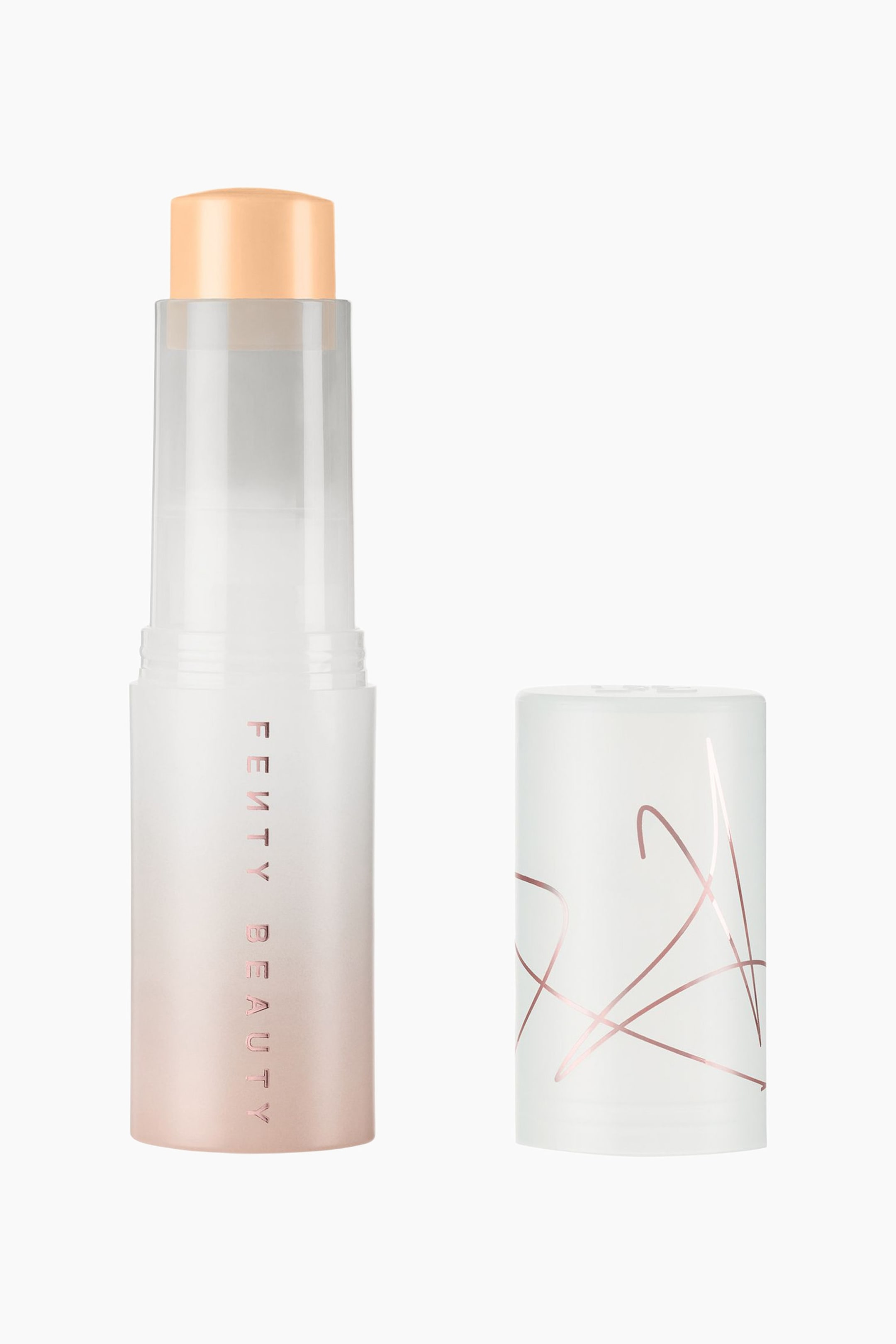 Visa större bild: Eaze Drop Blur + Smooth Tint Stick står upprätt med korken av, vilket avslöjar en rundad, ljusbeige krämprodukt. Den frostade cylindriska behållaren visar en gradient som övergår från halvgenomskinligt vitt till en mjuk roséguldfärgad botten med vertikal text, medan den avtagna korken står intill och visar abstrakt linjekonst i roséguld.