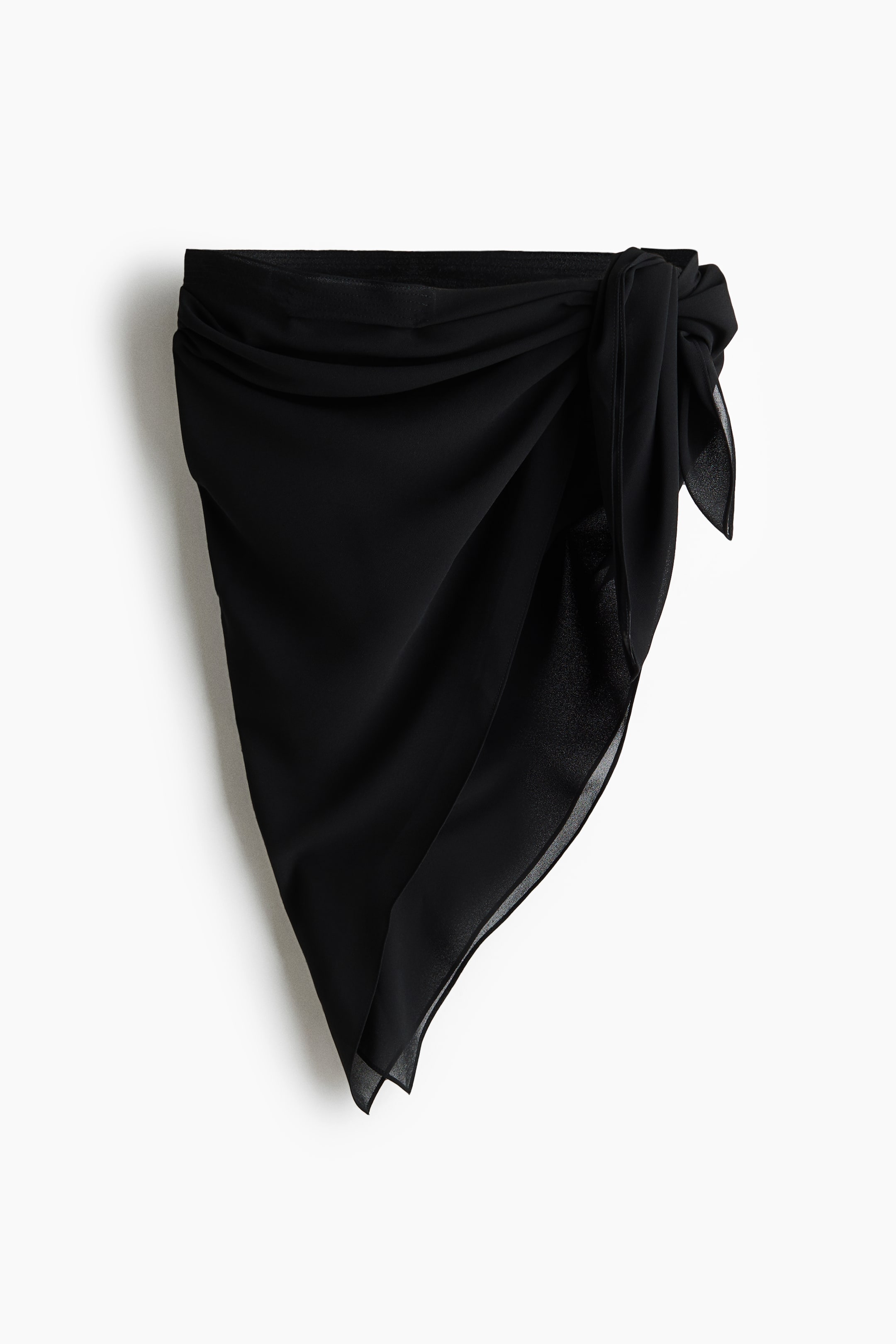 View larger image: A black sarong is showcased from the front, highlighting a knotted tie on the right side of its waistband, with the lightweight fabric cascading into an asymmetrical hem.