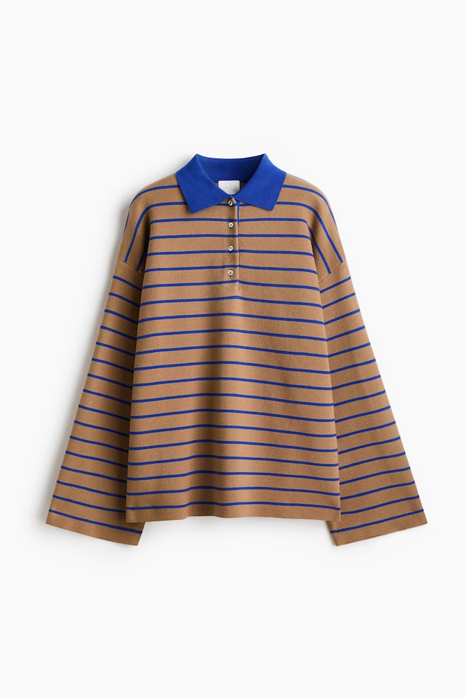 A knit polo shirt is shown from the front, featuring a brown and blue horizontal stripe pattern with a contrasting solid blue collar. The shirt is designed with a relaxed fit, showcasing drop shoulders, wide long sleeves, and a four-button placket. - 1