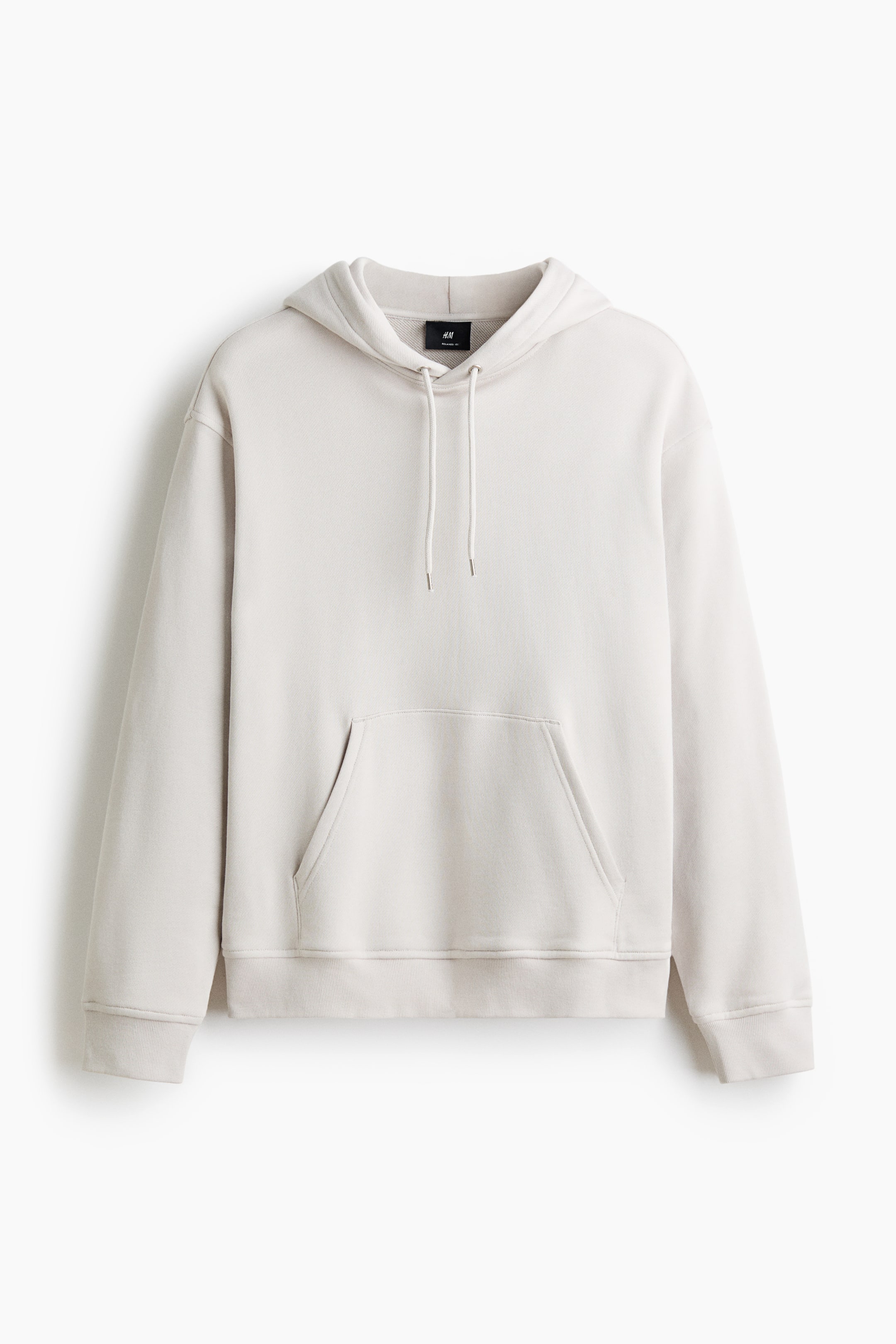 View larger image: A light beige hoodie is showcasing its front, highlighting a drawstring hood with jersey lining, dropped shoulders, and long sleeves with ribbed cuffs. It also features a kangaroo pocket and a ribbed hem, offering a relaxed fit.