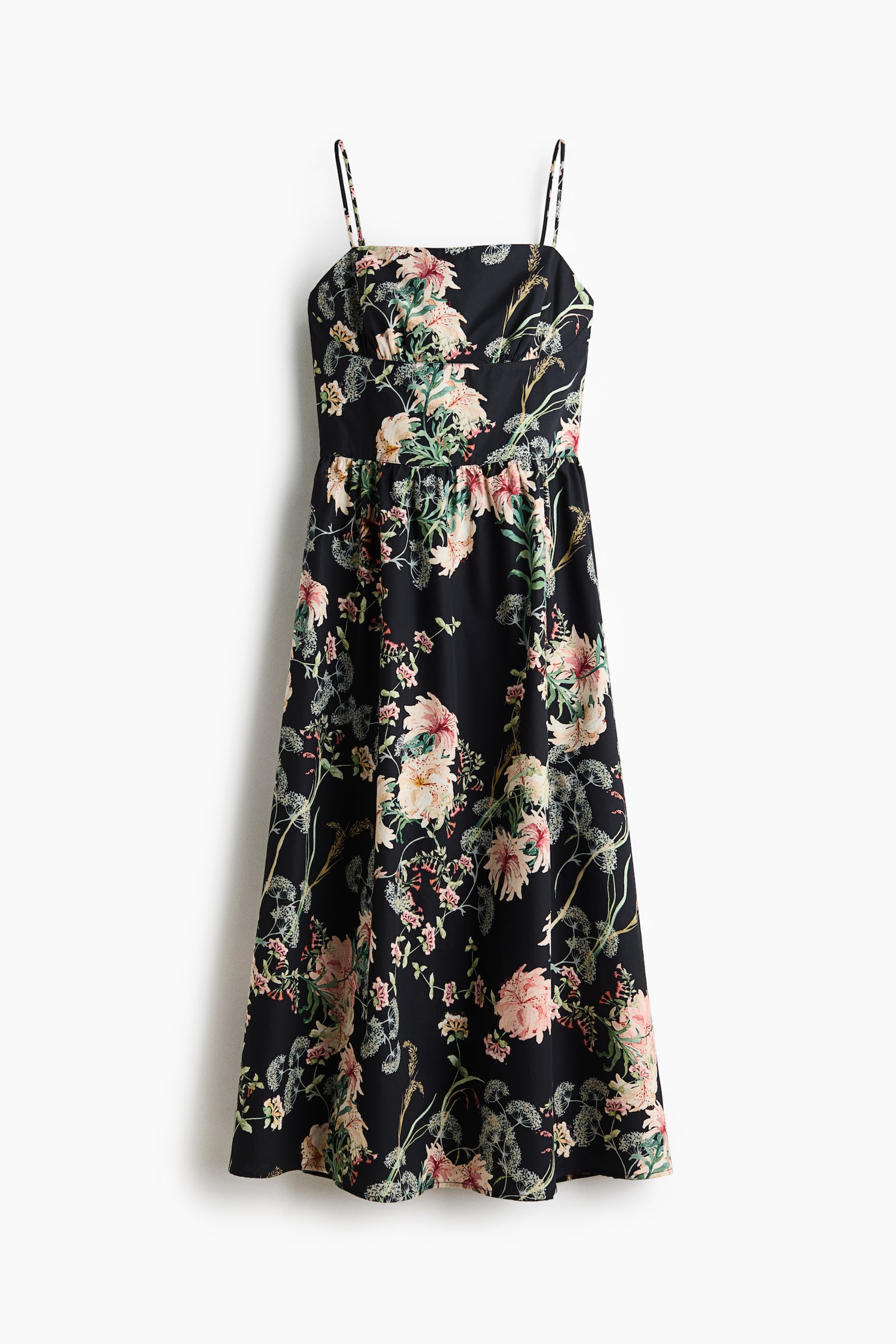 The dress is presenting front-facing, featuring a black base with an all-over floral print in shades of pink, green, and cream. It is designed with thin spaghetti straps, a gathered bust, and a full skirt reaching a midi length. - 1