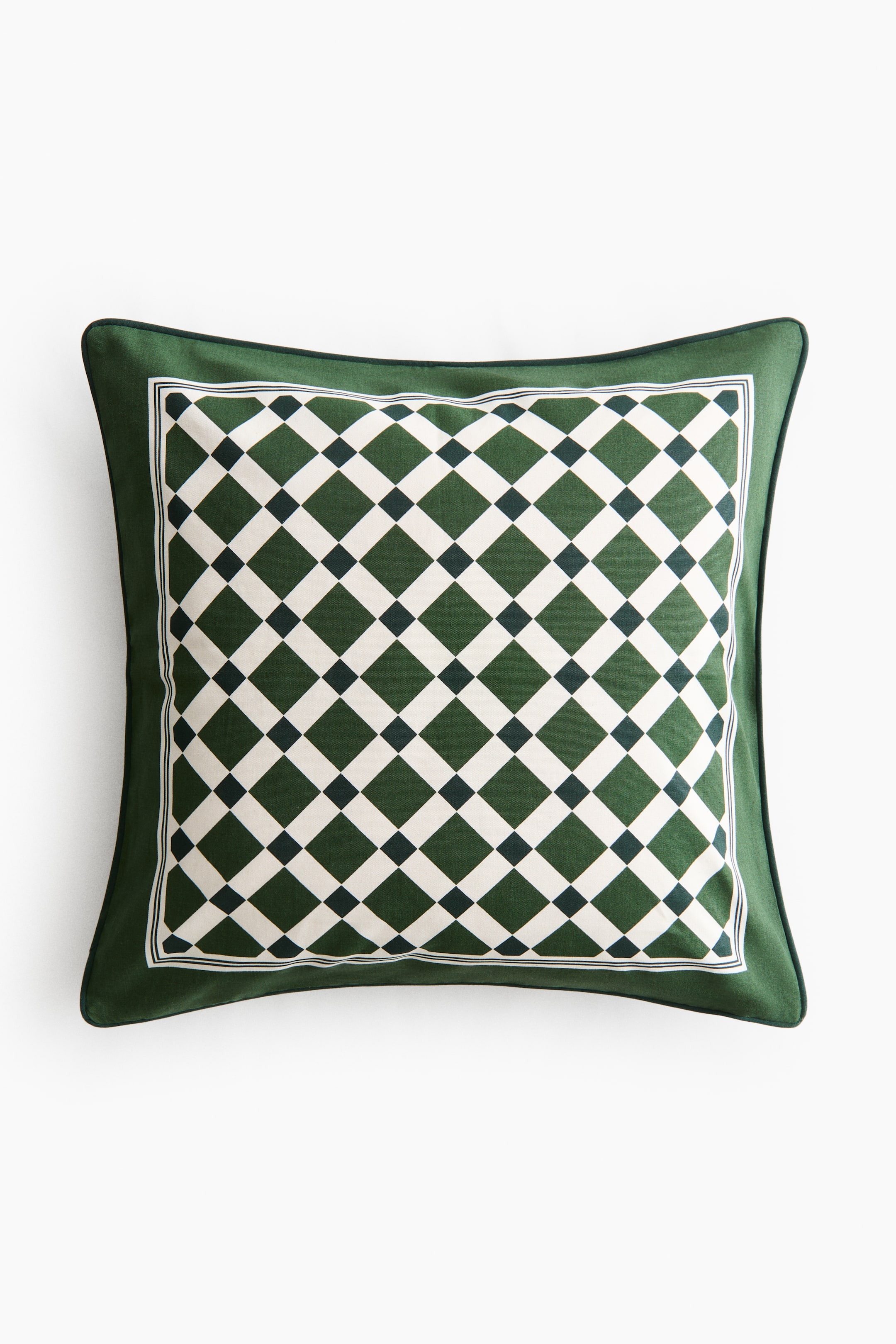 View larger image: A square cushion is shown front‑on, with a dark green outer border featuring a piped edge. The central panel displays a repeating diamond checkerboard pattern in white and dark green against a lighter green background, and is framed by thin white and dark green lines.