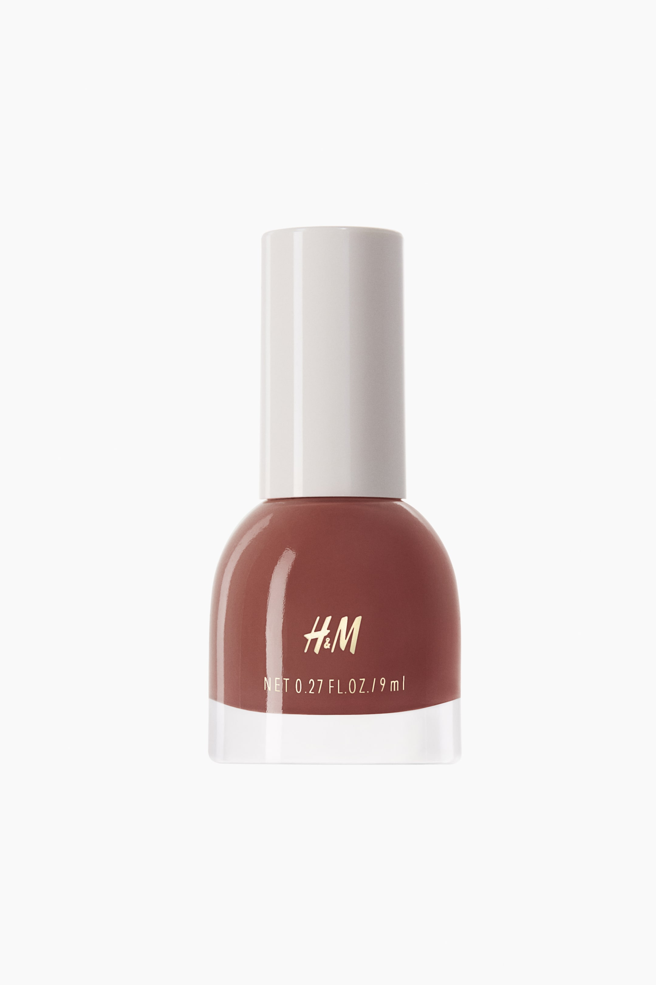 View larger image: Nail polish. A reddish-brown nail polish is showcased in a transparent glass bottle with a rounded base. Topping the bottle is a white cylindrical cap, adorned with the gold H&M logo and the text 'NET 0.27 FL. OZ. / 9 ml' prominently displayed on the front.