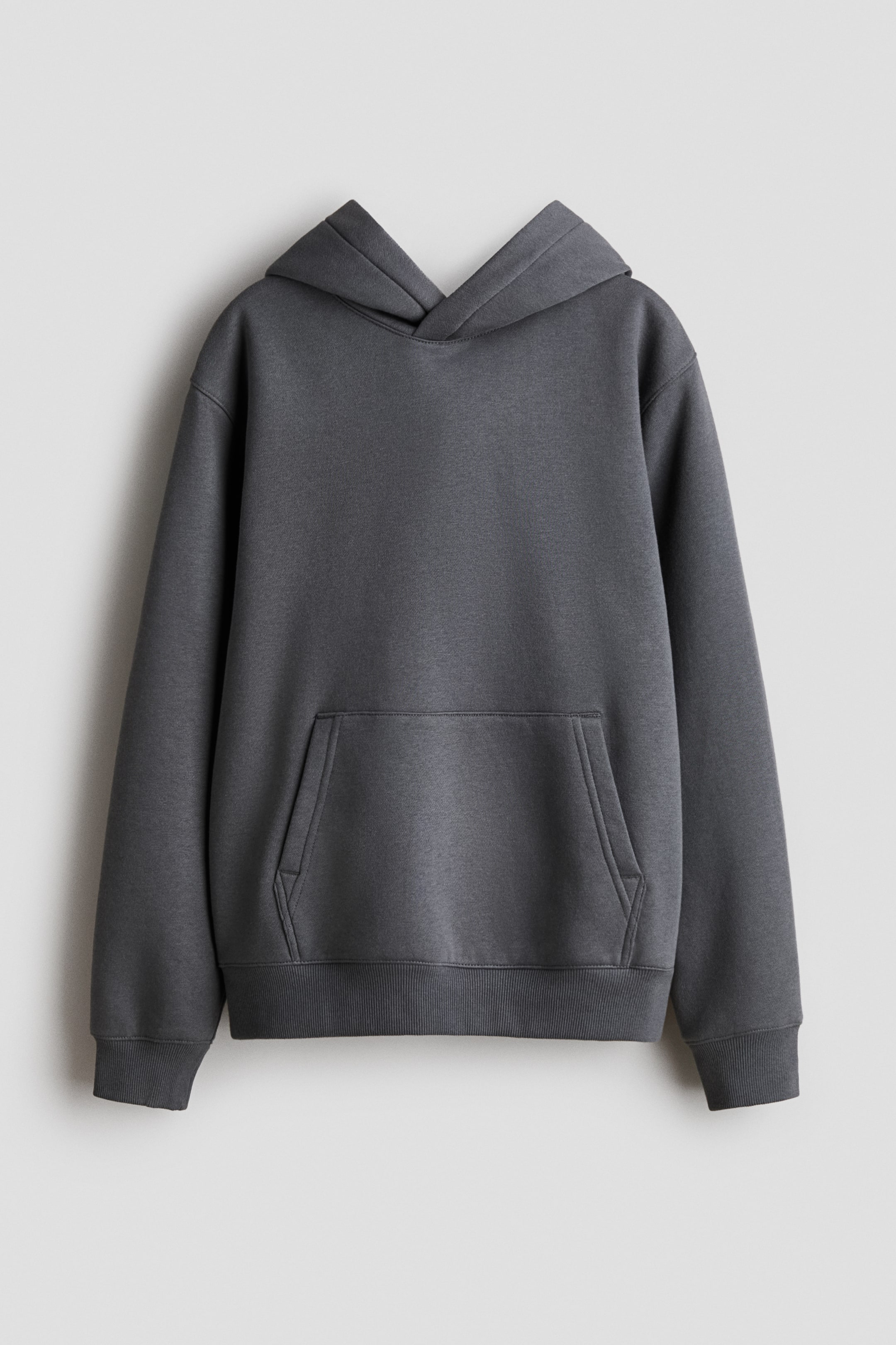 View larger image: A dark grey hoodie is facing forward, displaying a structured hood and long sleeves. It is featuring a large kangaroo pocket across the front, along with ribbed cuffs and a ribbed hem.