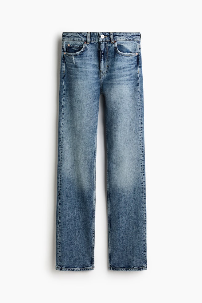 These five-pocket jeans in a medium blue wash are shown from the front, featuring a slim fit through the thighs and a narrow, straight cut to the hems. The jeans are shown with a low waist, button fastening, zip fly, and prominent fading across the thighs and knees. - 1