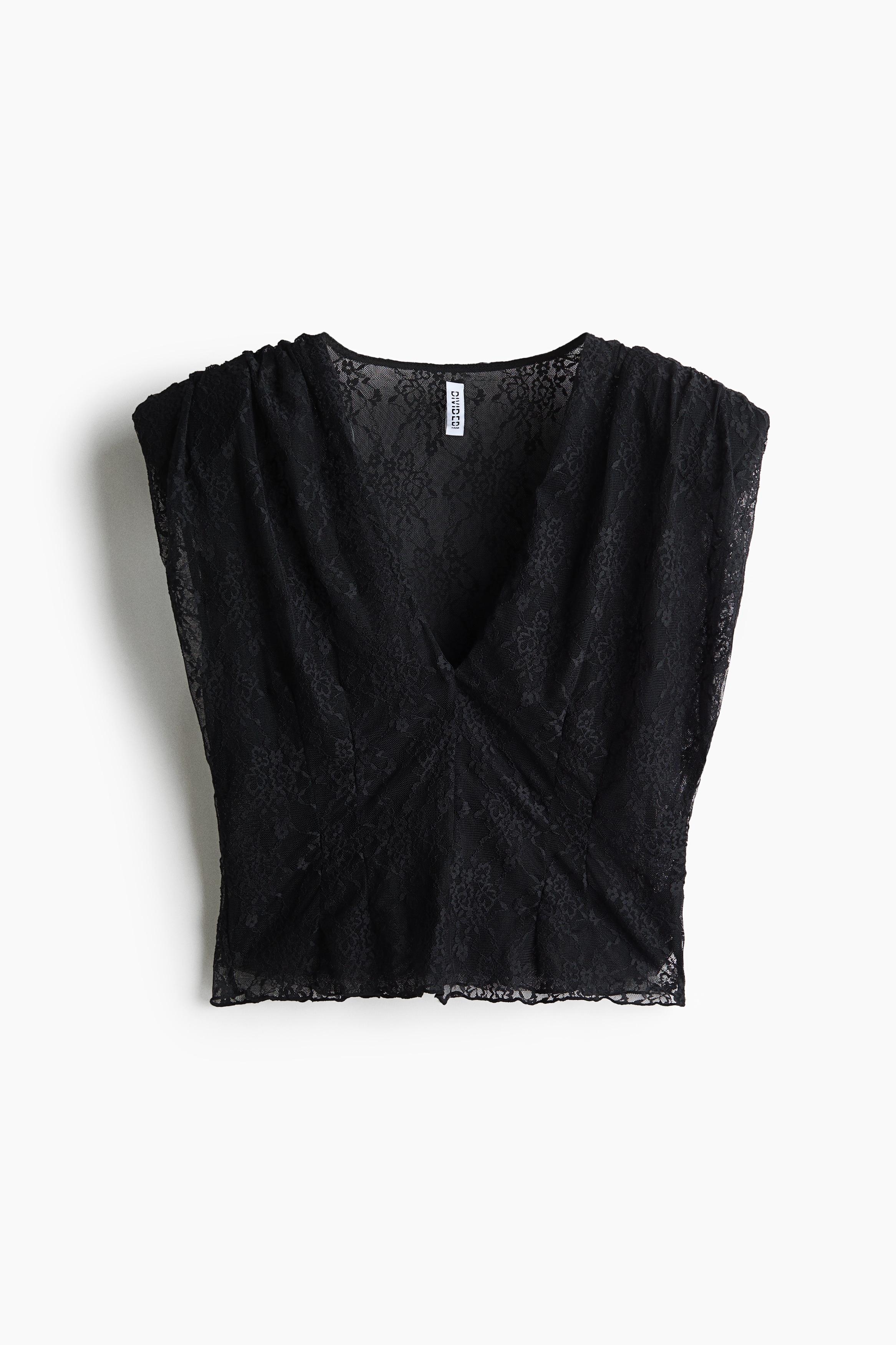 A short black sleeveless top in stretch lace, featuring a deep V-neck, gathered shoulders, and a straight cropped hem, is worn by the model. The top is styled with dark grey denim jeans.