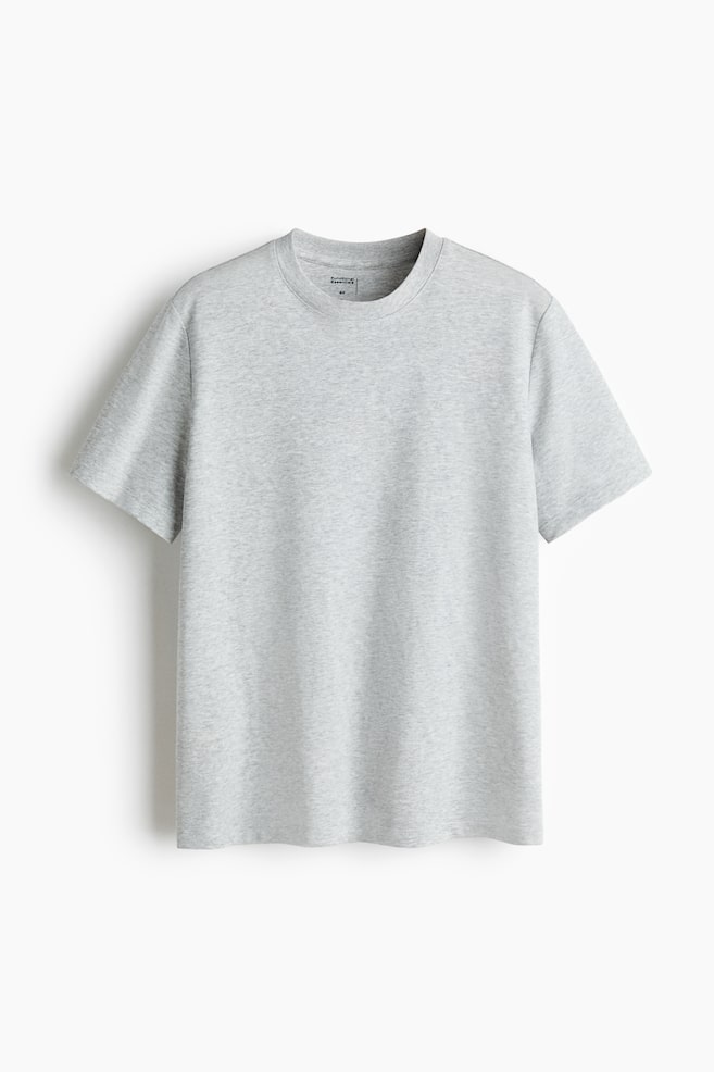 A light grey t-shirt is displayed from the front, featuring a regular fit, a ribbed round neckline, short sleeves, and a straight-cut hem. - 1