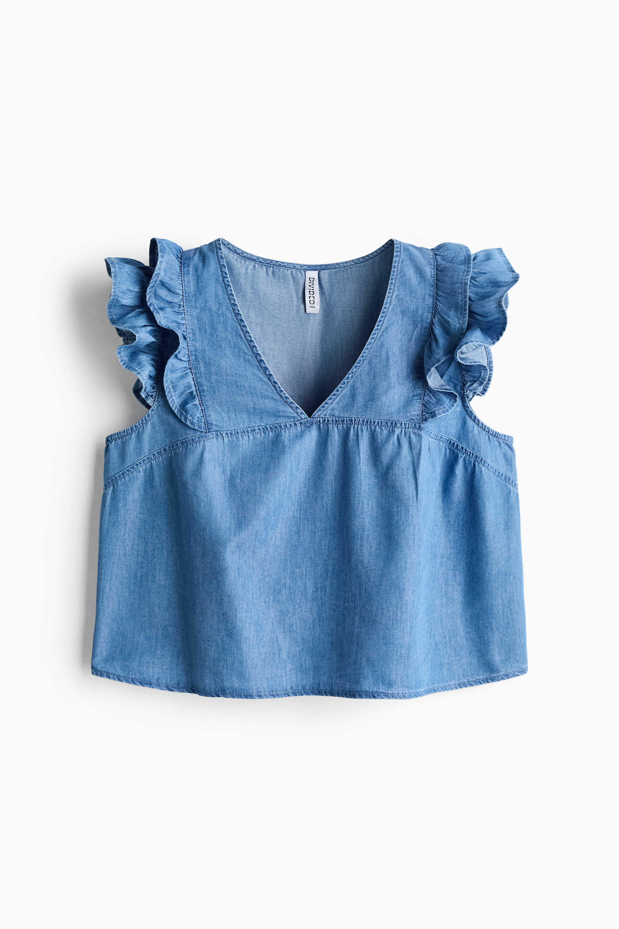 View larger image: Front view of a crisp cotton poplin top showcasing a V-neckline and short flutter sleeves. Frill trims extend from the front over the shoulders, with a gathered yoke visible across the front.