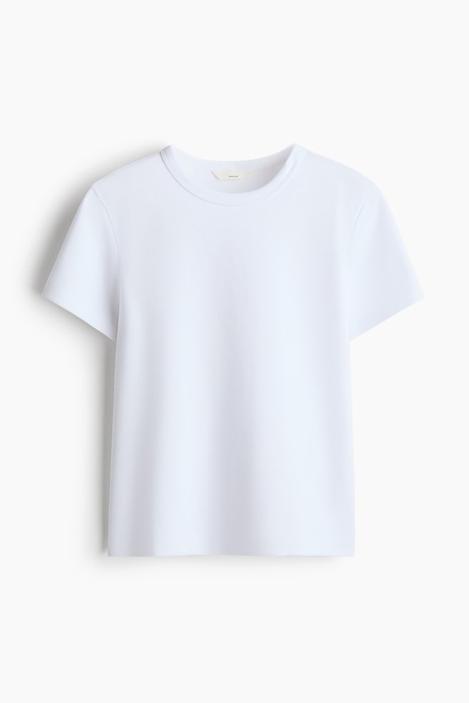 A white short-sleeved T-shirt is shown front-facing, featuring a classic ribbed crew neck, a straight hem, and a regular fit. - 1