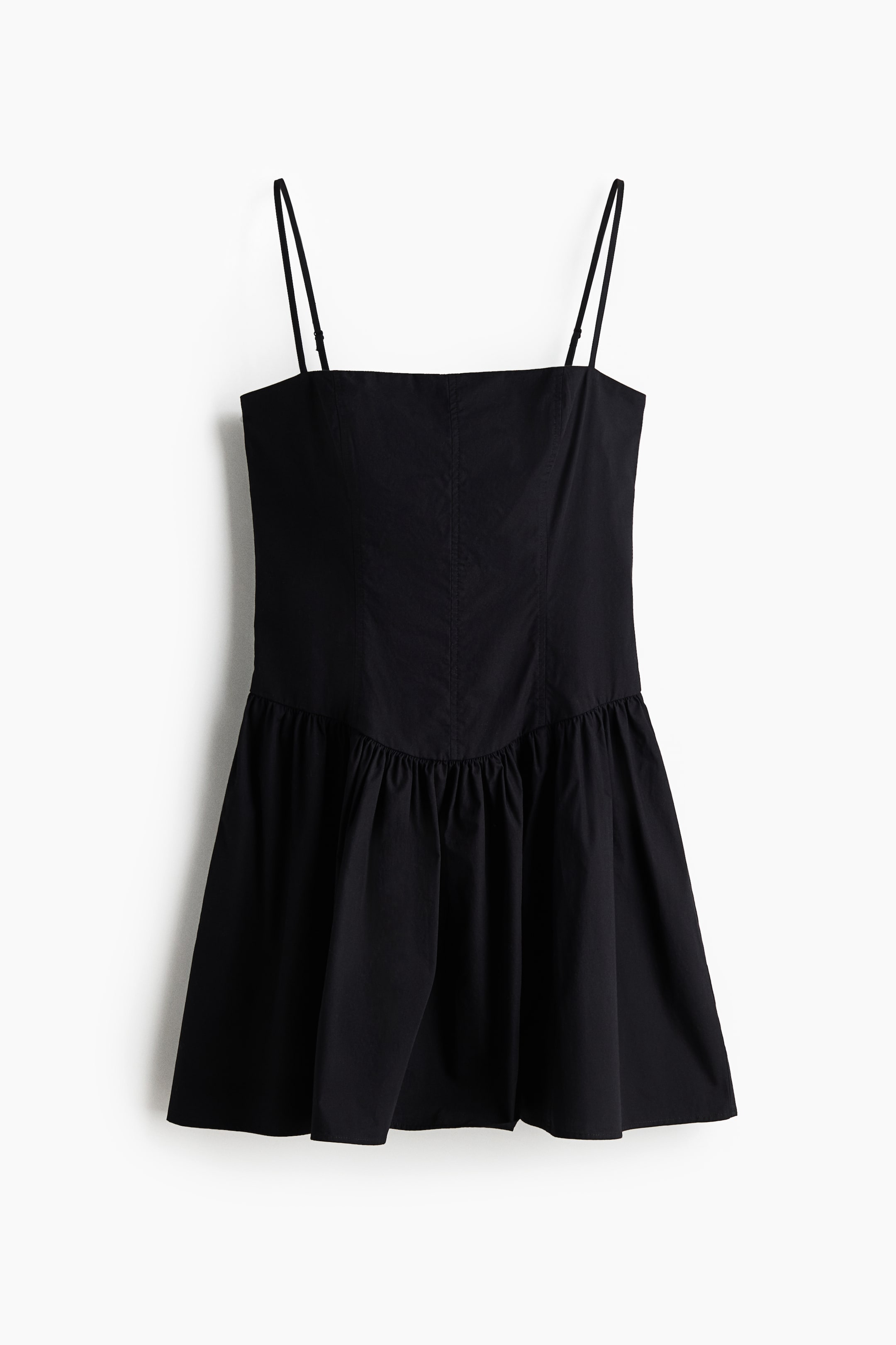 View larger image: The black mini dress showcases a straight neckline paired with delicate spaghetti straps. The bodice is tailored with vertical seams, while the short skirt gathers at the waistline, elegantly flaring outwards.