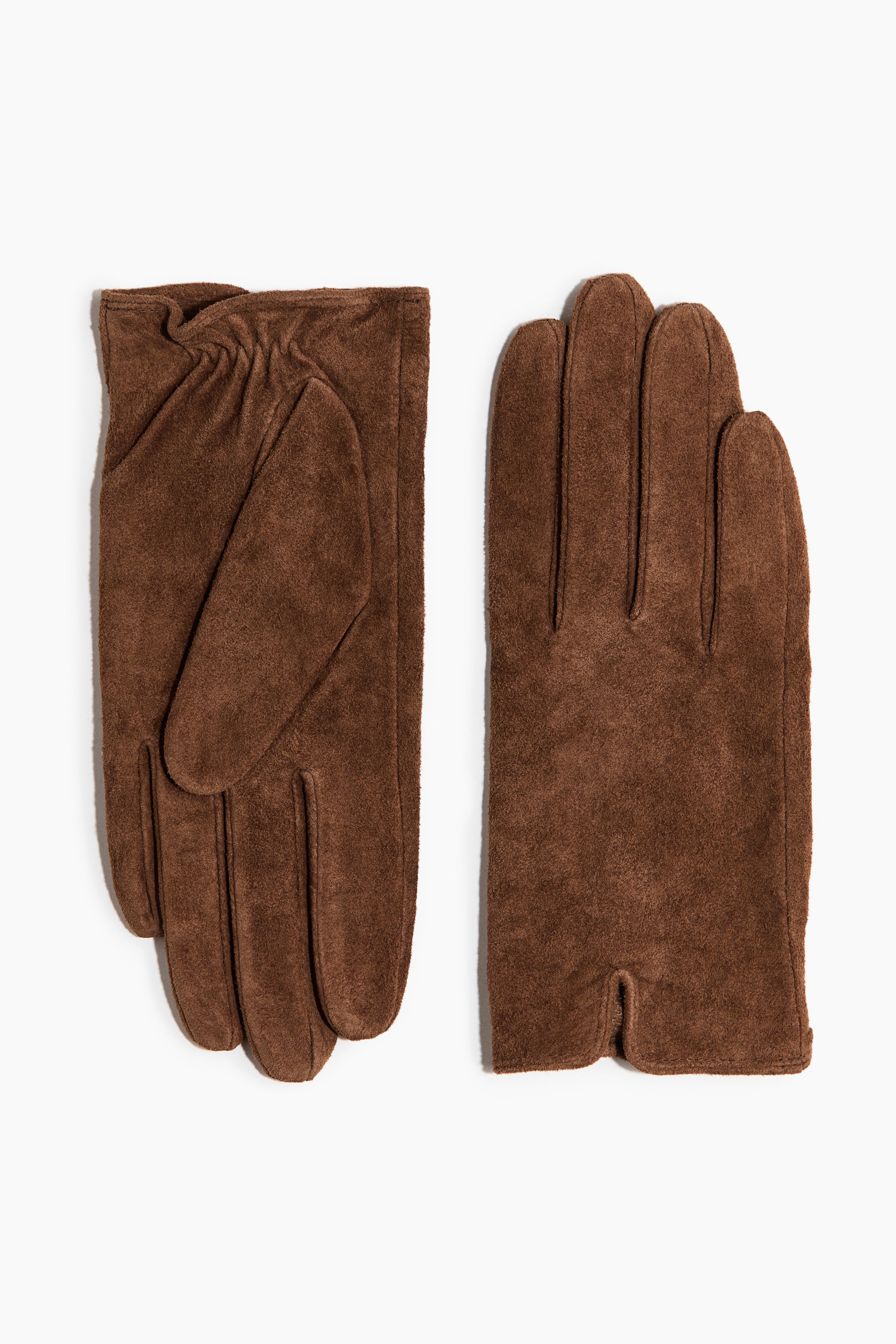 View larger image: Brown suede gloves are laid flat. The left glove features an elasticized wrist and a distinct thumb section on the palm side, while the right glove displays defined finger outlines and a short cuff vent on the back side.
