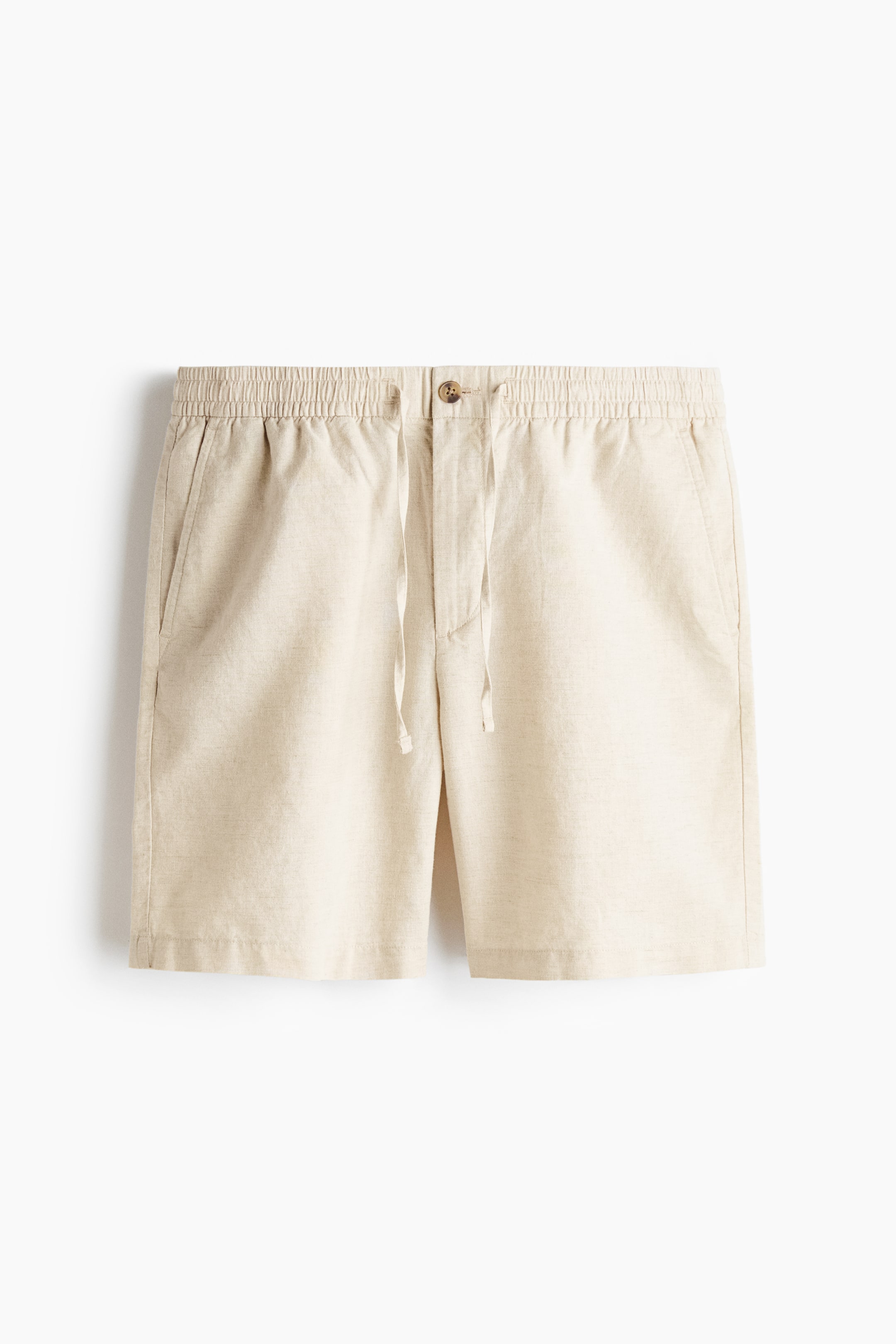 View larger image: The beige linen shorts are featuring an elasticated waistband with a drawstring and a single brown button closure at the front. 