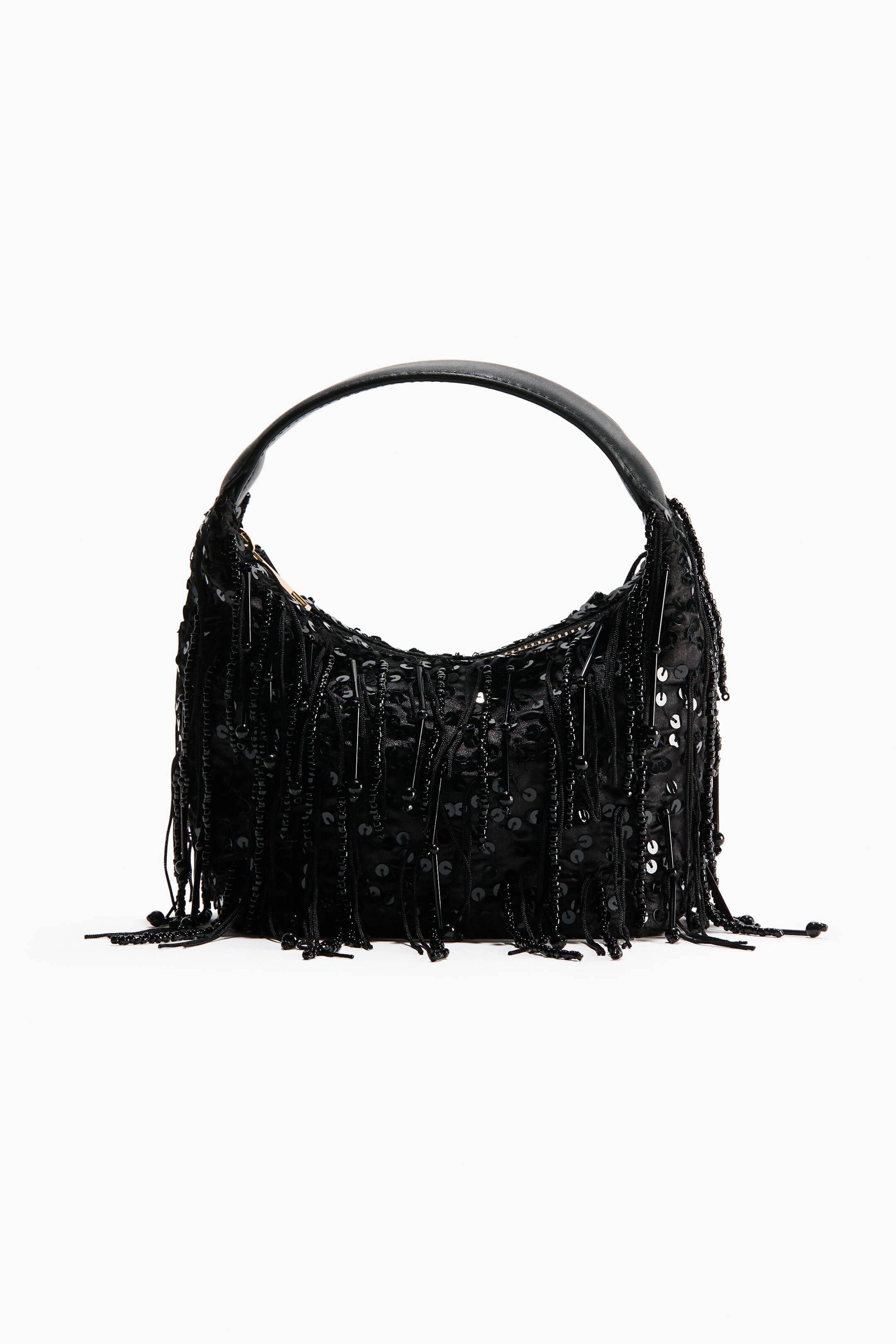 View larger image: A black hobo-style shoulder bag is facing front, featuring a crescent-shaped body covered in shimmering black sequins and dangling strands of beaded fringe. A smooth, curved black shoulder strap is arching over the top of the bag.