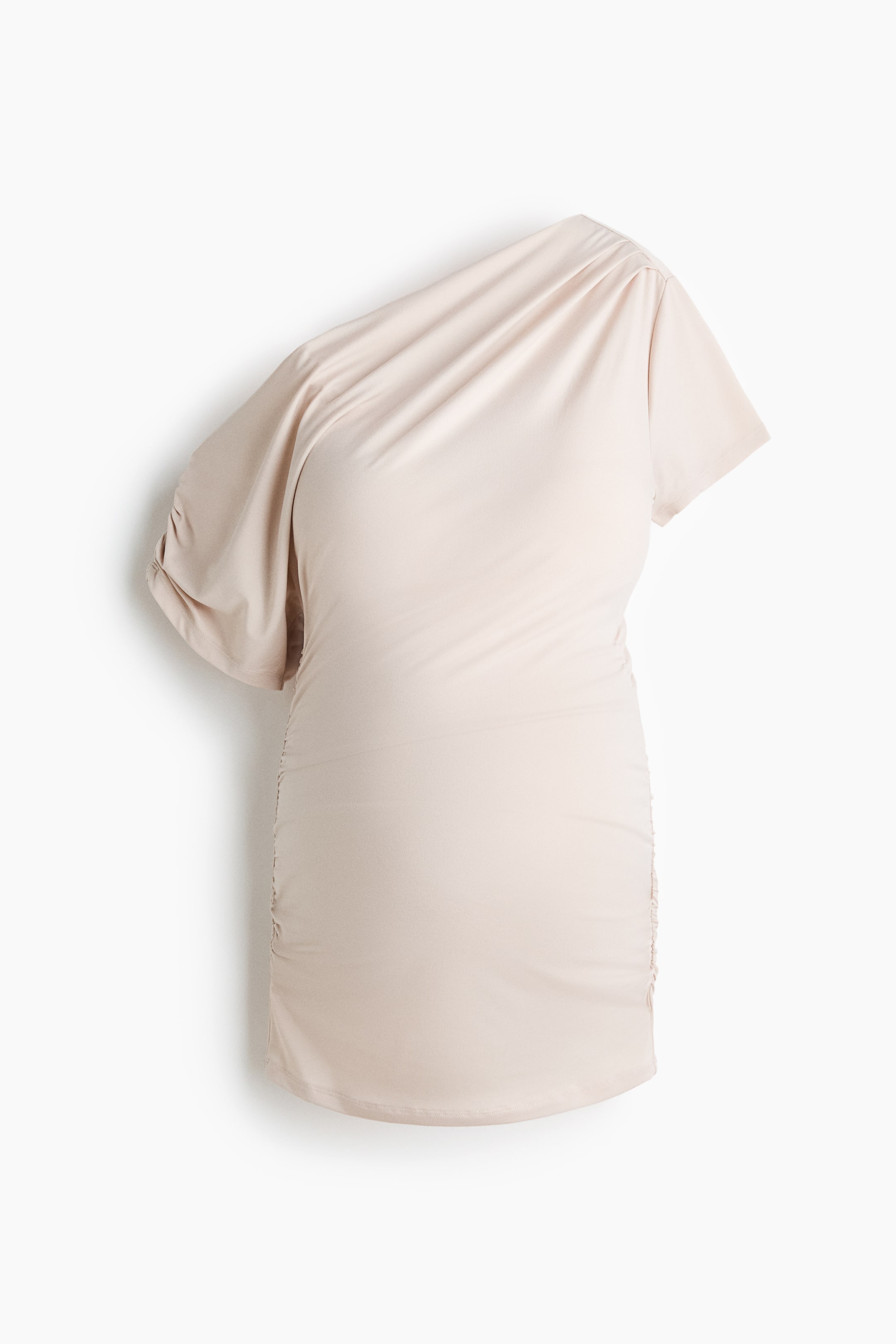 View larger image: A light beige one-shoulder dress showcases a short sleeve on its right side. The dress features gathered fabric at the shoulder neckline and ruching along the side seams, presenting a fitted silhouette.