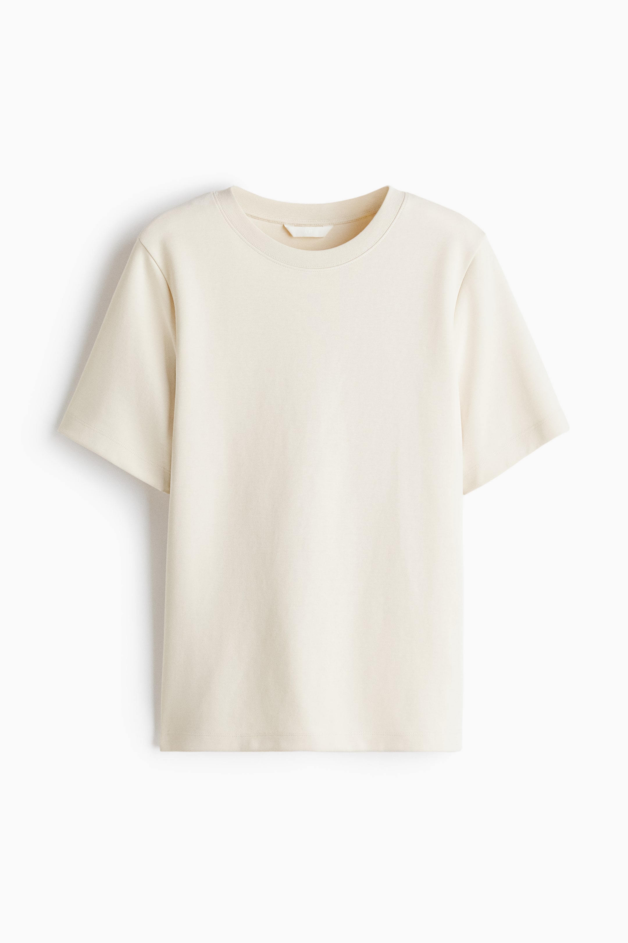 Grotere afbeelding bekijken: Een crèmekleurig T-shirt, vervaardigd van zware interlock jersey, toont zijn voorkant met een ronde, ribgebreide halslijn, korte mouwen en een recht gesneden zoom.